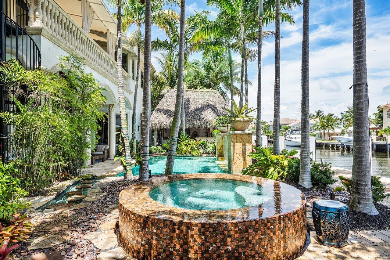 Welcome to 943 Jasmine Drive in Delray Beach's famed waterfront neighborhood, Tropic Isle. This magnificent waterfront modern transitional home is situated on a quiet cul-de-sac, has gone through a brand-new complete renovation showcasing the absolute most current styles and trends. Professional interior designers have taken careful consideration to create the perfect balance of luxury and open entertaining spaces. This home is comfortably spacious with six en-suite bedrooms, first floor suite and powder room, gourmet chef's kitchen with informal dining and living rooms, formal dining room, sitting room, magnificent covered outdoor entertaining area that features a pizza oven, full kitchen and covered patio overlooking the resort-like pool and dock. Uncommon construction highlights include entire home, pool and dock built on cement pilings, wide plank Brazilian wood floors, polished marble floors, butler's pantry with wet bar. Additional features include an elevator, floor to ceiling hurricane impact windows and doors, whole house generator with automatic transfer switch, gas fireplace, three garage bays, two underground propane gas tanks, pool with heated spa, custom ceiling and wall details, oversized laundry room and a magnificent, covered patio / tiki setting you would only find in a luxury tropical resort. Tropic Isle is ideally located just moments from famed Atlantic Avenue where you will find high end boutique shops, restaurants and night life, and the beach. For the yachtsman, we are conveniently located on a wide deep-water canal with no fixed bridges between the Boca Raton and Boynton Beach inlets. If you have been looking for a home built far above the norm, your search is over. Welcome home!