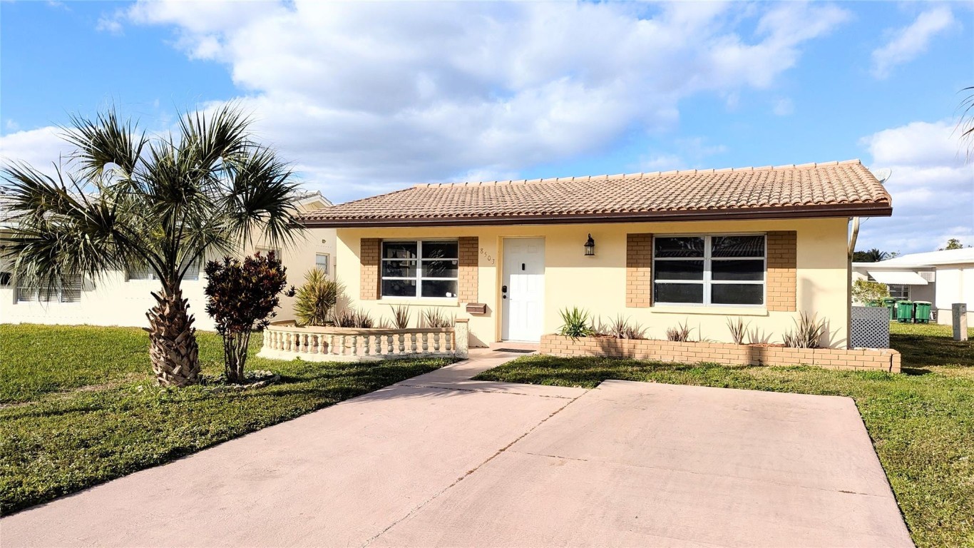 Great home located in the Mainlands of Tamarac Lakes. This home features a spacious living room, dining room, updated kitchen, 2 bedrooms, 1 bath, den, utility room with washer & dryer, ceiling fans, central air, ceramic tile floors and wood floor, This 55+ Community has a low maintenance fee and centrally located near the Turnpike and Sawgrass Expressway. AC 2022 Flat Roof 2022 Tile Roof 2007 W/D, Refrigerator, Dishwasher, Oven, Range, Microwave 2022