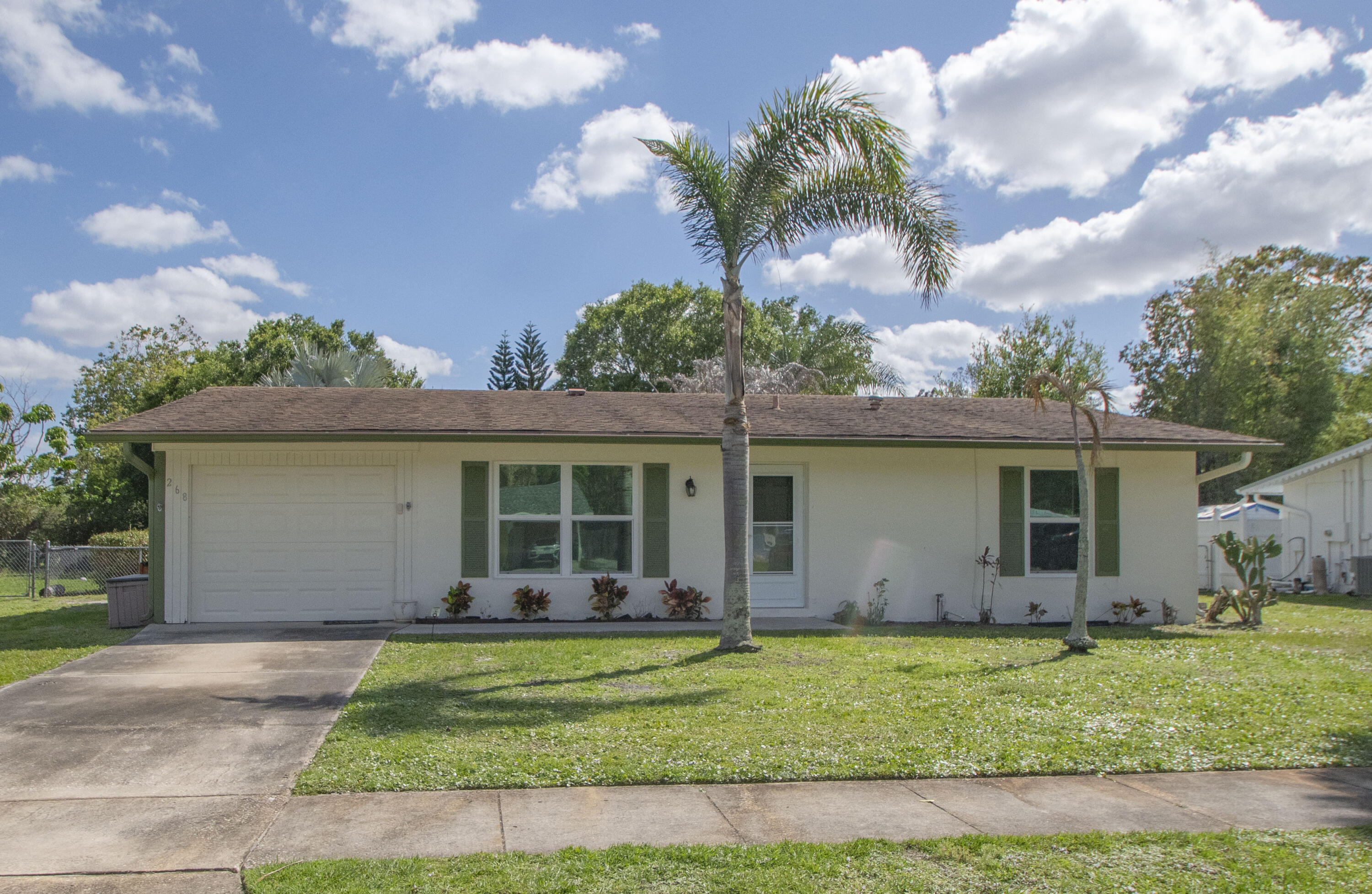 This cute 2/2/1 is a perfect starter home or investment property in the middle of Port St Lucie. Close to everything... parks, shopping, restaurants, houses of worship and a new library coming soon.  Florida room was enclosed to add almost 300 sf to living sf. Hurricane/Impact windows installed in 2024. CBS Construction. AC and Pest Service done regularly. Freezer in Utility Room stays.  Big fenced back yard has plenty of room for a pool. Sold AS-IS. All sizes approximate, buyer/buyer's agent to verify.  Magnolia Tree in back yard does not convey.