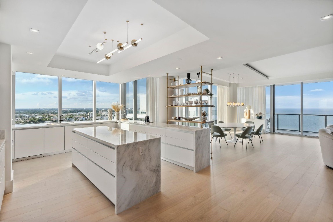 One of a kind combination corner residence at the new Auberge Beach Residences. Original owner combined two units into the most spectacular 5 bedroom, 5 bath unit with 4,241 sq/ft of interior living space. Professionally designed by DKOR Interiors, no expense was spared when finishing the unit with custom built-ins, wood flooring, closets, window treatments and furnishings. The 180 degree views from this NE corner flow-thru unit include direct ocean, intracoastal and downtown views. The kitchen was custom designed to be one of the largest at Auberge and includes an island, 2 full size wine coolers and gas cooktop. 4 parking spaces included. Auberge offers 5 star amenities including: upscale restaurant and spa, fitness center, two pools, cinema, golf simulator, billiards, wine room etc