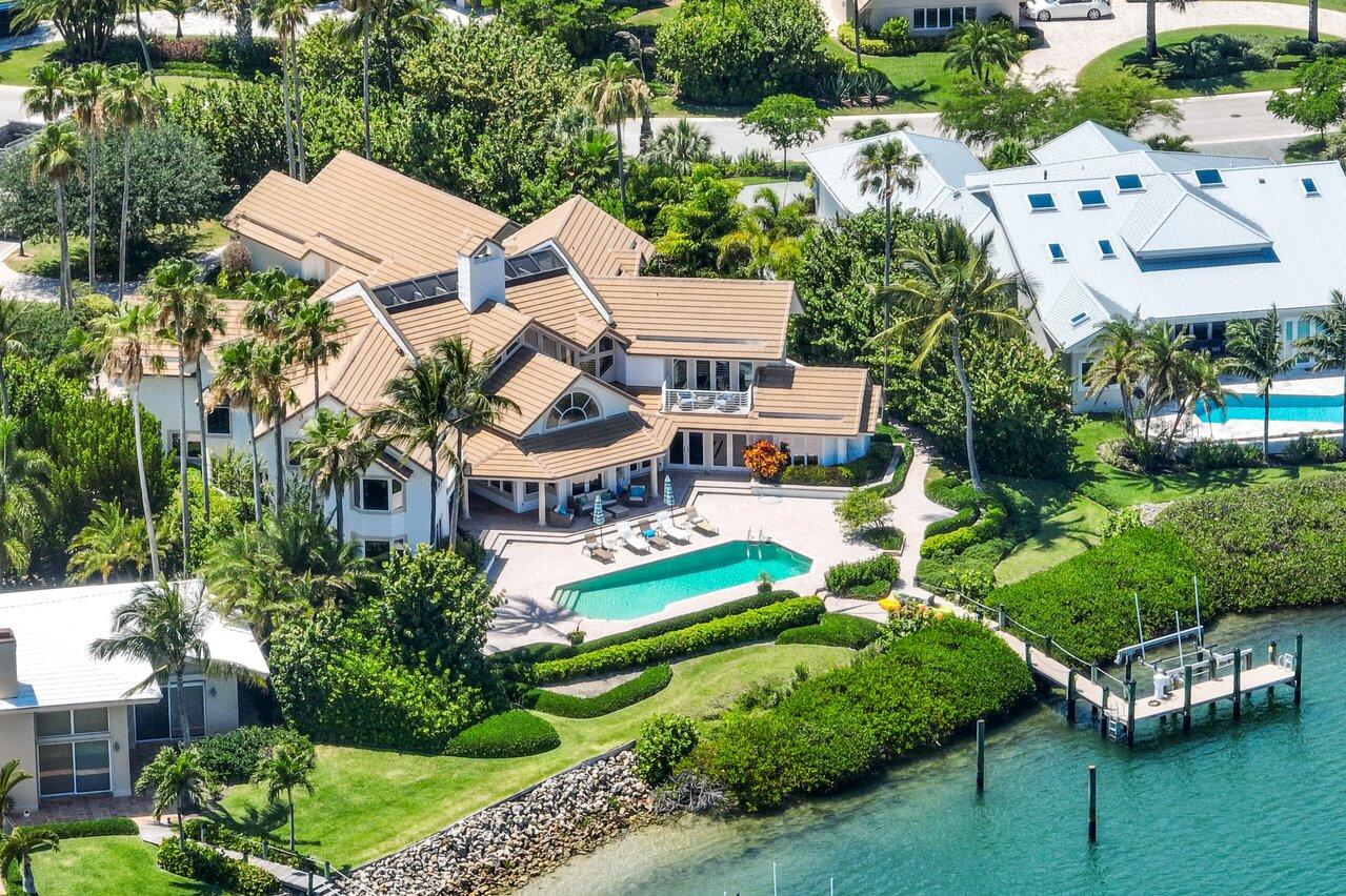 Impressive waterfront home on the harbor with southeast exposure. 110 ft of water frontage with deep water dock. Five bedroom with office/sixth bedroom house with six full ensuite bathrooms. Master suite with private balcony. Additional balcony in guest bedroom overlooking harbor. Covered verandas. Wonderful pool deck. Private deep water dock offers access to the ocean in minutes. Sailfish Point's unique location directly on the Atlantic Ocean and St. Lucie Inlet at the Southern tip of Hutchinson Island, makes it a community like no other. Residents enjoy five miles of pristine shoreline, oceanfront Jack Nicklaus 'Signature' golf, elegant beachfront country club and full-service marina with immediate ocean access. Resort-style amenities include state-of-the-art fitness complex, spa/salon, Har-Tru tennis courts and the ultimate in private security.