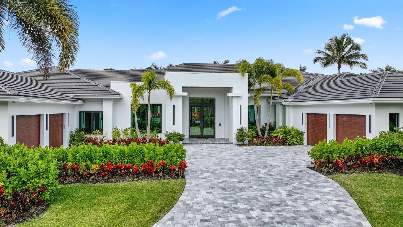 Nestled within the prestigious gated community of Long Lake Estates, this newly constructed contemporary architectural masterpiece offers an unparalleled opportunity to own a true trophy property. Situated on an acre plus and spanning over 7,400 interior square feet of meticulously curated living space, this one story exceptional estate seamlessly blends modern sophistication with timeless elegance. After entering through 10 foot high glass doors, a striking statement entry foyer welcomes you into a grand great room and living area, with oversized porcelain floors and floor-to-ceiling windows showcasing breathtaking views of the resort style backyard. Designed for both relaxation and entertaining, this property seamlessly blends indoor and outdoor living at its finest. This expansive home boasts 5 bedrooms, 6 full baths, a half bath, along with a state-of-the-art home theater and a spacious 4 car garage. Every bedroom suite features oak flooring, custom closets, stunning bathrooms and is thoughtfully designed with meticulous attention to detail, offering both comfort and sophistication. The primary suite is a true sanctuary, showcasing unparalleled style and luxury. Oak flooring and floor-to-ceiling glass doors lead to an oversized private patio. His-and-her spa-inspired bathrooms are connected by a stunning glass-enclosed shower, while the suite also features tremendous custom his-and-her walk-in closets and a private sauna for the ultimate retreat. The chef's kitchen is a true masterpiece designed for both function and style equipped with top-of-the-line appliances, by SubZero, Wolf, Bosch and Miele ensuring effortless functionality and luxury at every turn. At its heart, a massive center island provides ample workspace, under-storage, and casual dining. Dropped backlit ceilings enhance the ambiance, while sleek, soft-touch wood veneer cabinets offer both beauty and practicality. Completing this extraordinary kitchen is an adjacent walk-in pantry, offering additional storage and organization to keep everything within easy reach. The elegant dining room with a stunning matchbook quartz feature wall is complemented by two stunning glass-enclosed, temperature-controlled wine displays, creating a sophisticated ambiance for wine enthusiasts. An oversized great room serves as the heart of the home, featuring a stunning porcelain accent wall and a sleek propane fireplace, creating an inviting ambiance. The open-concept dining area connects to the outdoors through expansive glass sliding doors, offering effortless indoor-outdoor living. Step outside to a true entertainer's paradise, boasting three covered patios, a resort-style pool and spa, a cozy fire pit, and a fully equipped summer kitchenperfect for hosting gatherings or enjoying tranquil evenings in your private oasis.