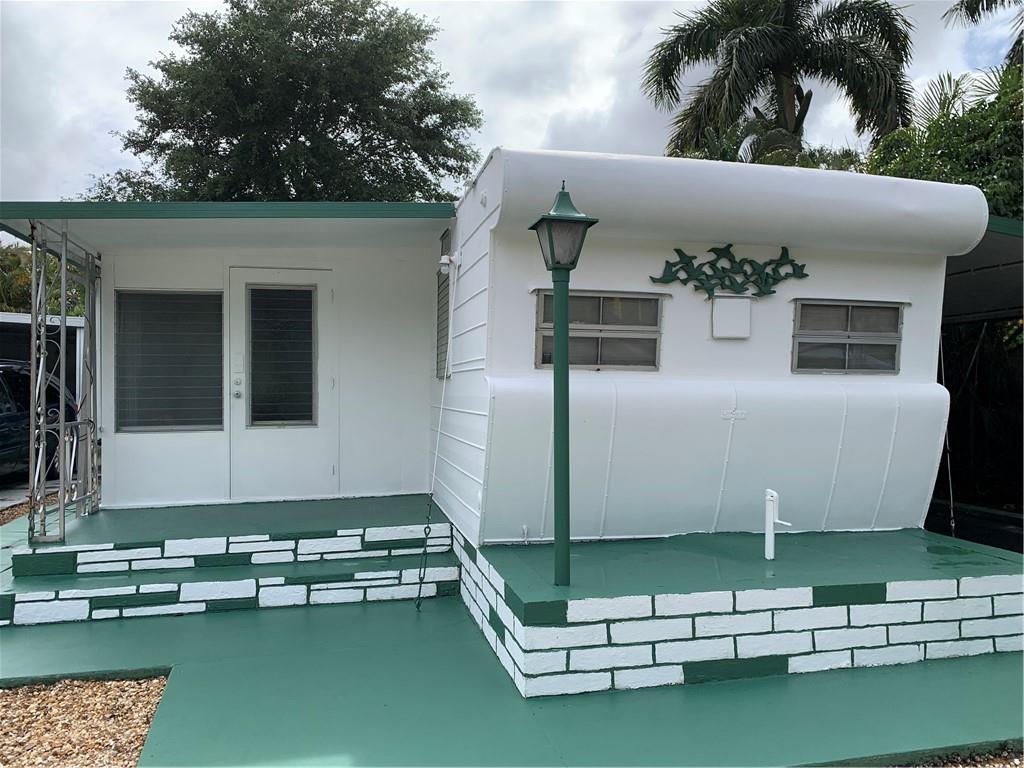 Used as a second home for over 20 years. Comes fully furnished including stocked kitchen. Clamshell hurricane shutters. Has Front and Rear porches. No view of neighbors on all four sides. Solid brick skirting.  Freshly painted outside.  Linoleum floors throughout. Freshly finished driveway. Needs Updating and Roof and Ceiling. HOA only $77.55 per month.  You own the land. Great lifestyle in 55 plus retirement community with 3 pools, minigolf, lots of activities and community functions to attend. Close to shopping, grocery stores, malls, restaurants, home improvement, everything from A t Z minutes to hospitals and highways. Best location in Broward County and most affordable living. Broward County transportation in park.