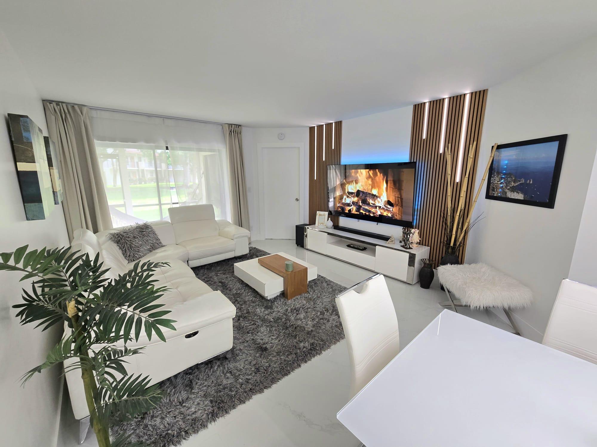 Charming 2/2 condominium nestled in the Courtyard at Coral Gate community. This completely redone condo offers high-end upgrades with custom kitchen cabinets, quartz countertops, new stainless-steel appliances, and new washer and dryer. Beautiful custom-built accent wall with integrated LED lighting. This striking designer feature adds warmth, depth, and a modern touch, creating an elegant focal point. Large porcelain tiles throughout. Updated baths w/exquisite finishes. All new LED lighting throughout. Custom-built closets. This ground-floor unit features 3 patios, nice pool views & extra storage space. Newer A/C & water heater. Across the street from city park which offers, tennis courts, basketball, playground and grills. Pet-friendly community. Water and cable included in condo fees.
