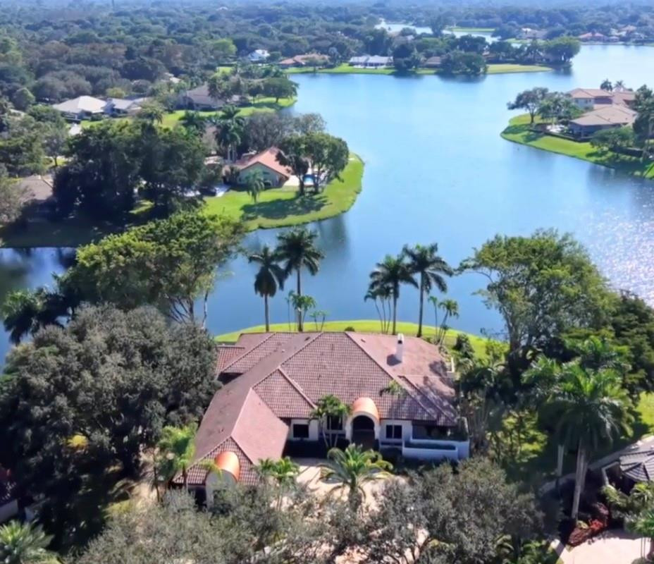 Magnificent home is the Florida luxury retreat, masterfully renovated to blend sophisticated modern design w idyllic waterfront living nestled on a quiet cul-de-sac. Open-concept layout maximizes breathtaking wide-water views, seamlessly integrating indoor luxury w serene outdoor environment. Wide-water views from various points in the home & from the oversized patio- pool area. Entire home meticulously renovated w a contemporary luxe interior design, high-quality finishes, attention to detail. 7 bedrooms & 5.5 bathrooms, attached guest house for multi generational living, Chef's kitchen, 4 AC's, impact window & doors. A showcase of high-end finishes & impeccable craftsmanship, designed a tranquil & luxurious lifestyle. One mile walk to house of worship & school, close to shopping & parks Key spaces include:• Gourmet Kitchen: A chef's dream, large, fully-fitted kitchen includes high-end appliances, solid wood cabinetry, ample counter space, and modern touches like silent-close drawers. Perfect for entertaining or daily culinary pursuits. • Bathrooms: Master baths resembles a spa retreat, complete with features such as a deep soaker tub, separate shower, his and her sinks, and elegant fixtures.• Versatile Guest House: The attached guest house offers privacy for visitors or an ideal space for a dedicated entertainment area, multi generational living or "man cave"• Durability and Comfort: The property has been thoroughly upgraded with practicality in mind, including impact glass and doors throughout for peace of mind, and four newer AC units for optimal climate control. New lighting throughout.Property Highlights:• Breathtaking Water Views: Enjoy mesmerizing, wide-water views from various pointsin the home, or outside on the oversized patio and pool area maximizing the serene waterfront lifestyle. Partial screened patio, new fence summer kitchen, outside built in bar.• Modern Elegant Renovation: The entire home has been meticulously renovated with a contemporary luxe interior design, featuring high-quality finishes, attention to detail, and a sophisticated atmosphere.• Spacious Living: The property boasts 7 bedrooms and 5.5 bathrooms, providing ample space for family and guests.• Premium Upgrades Galore • Durability & Safety: Equipped with impact glass and doors throughout for enhancedsecurity and protection.• Utmost Comfort: Features four newer AC units ensuring optimal climate control and efficiency.• Exquisite Details: The renovation includes high-end materials such as quartz countertops, custom cabinetry, modern lighting and seamless indoor-outdoor transitions.This residence is a showcase of high-end finishes and impeccable craftsmanship, designed for those seeking a tranquil and luxurious lifestyle in a sought-after waterfront location.Community pool, tennis courts, pickle ball, guard gate, clubhouse included in HOA dues