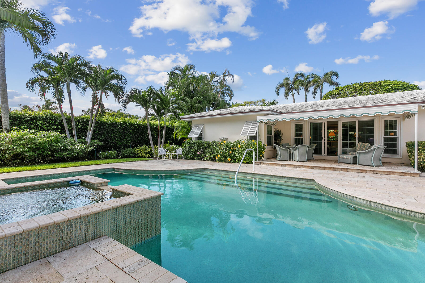 Classic Palm Beach 4 Bedroom 3 Bath Pool Home on Oversized Lot in Desirable North End of the Island.

Situated on more than ¼ acre of land, this tastefully updated Ranch Style home ideal for entertaining with open floor plan, offers a spacious sun-filled dining room, large living room and creatively crafted kitchen with custom cabinetry, built-in bar and kitchen workstation. 

Main house offers 2 lovely bedrooms with stunning wood flooring, plenty of closet space and 2 bathrooms with walk-in showers. Separate tiled guest cottage, connected by covered walkway, offers two additional bedrooms, respective sitting room and full bath. 

Privacy and tranquility prevail in the spaciously secluded, yet sizeable backyard retreat boasting a timelessly designed heated pool with spillover spa Covered patio for house and cottage, as well as expansive pool decking, offer extended areas for outdoor dining and overflow entertaining space while enjoying this meticulously landscaped property surrounded by privacy hedges. 

This gracious home offers complete impact doors and windows, a generously sized two car garage and plenty of parking on the driveway's beautifully maintained pavers.

Merely one block from the ocean, enjoy access to the wide private north end beach with shared cabana access, or take a leisurely bike ride along the Intracoastal waterway with access directly across the street!