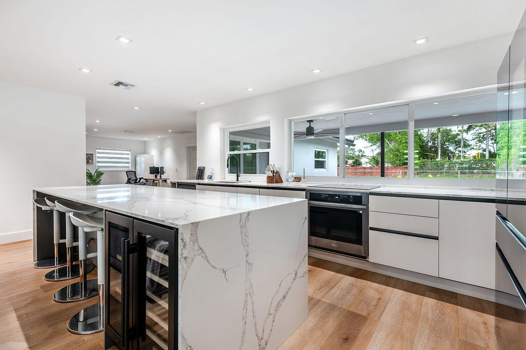 Beautifully renovated, custom-designed 3BR + den / 2BA pool home in Central Boca on an oversized canal-front lot with total backyard privacy—in a coveted NO-HOA neighborhood with A+ rated schools, an amazing location, and walking distance to Pine Crest School.  Tons of space w/ 2 Living areas, epoxy-finished AC garage, and large walk-in closets in every room including a custom master closet. The chef's kitchen boasts a triple-waterfall island, custom cabinetry, wine cooler, beverage fridge, and Samsung appliances. Smart home: Google Home, automated blinds, and recessed lighting throughout. Step out to a private saltwater pool oasis with canal views, cabana bath, and patio seating. Hurricane-impact windows/doors, new AC, updated roof, and EV hookup.  Lawn, pool, and pest included. $6,000/mo Available July 2026. Minimum 12-month lease. Strong credit, verifiable income, background check, and rental history required. Landlord covers lawn, pool, and pest care. Tenant responsible for utilities and internet.   No smoking. Pets considered on a case-by-case basis with landlord approval.   Hurricane-impact windows and doors throughout. EV charger hookup in garage. Walking distance to Pine Crest School and close to Blue Lake Elementary and Omni Middle.  Home has been extensively renovated and meticulously maintained. Landlord seeking tenants who will care for the property accordingly. Furniture is negotiable. Lawn, pest and pool care included.