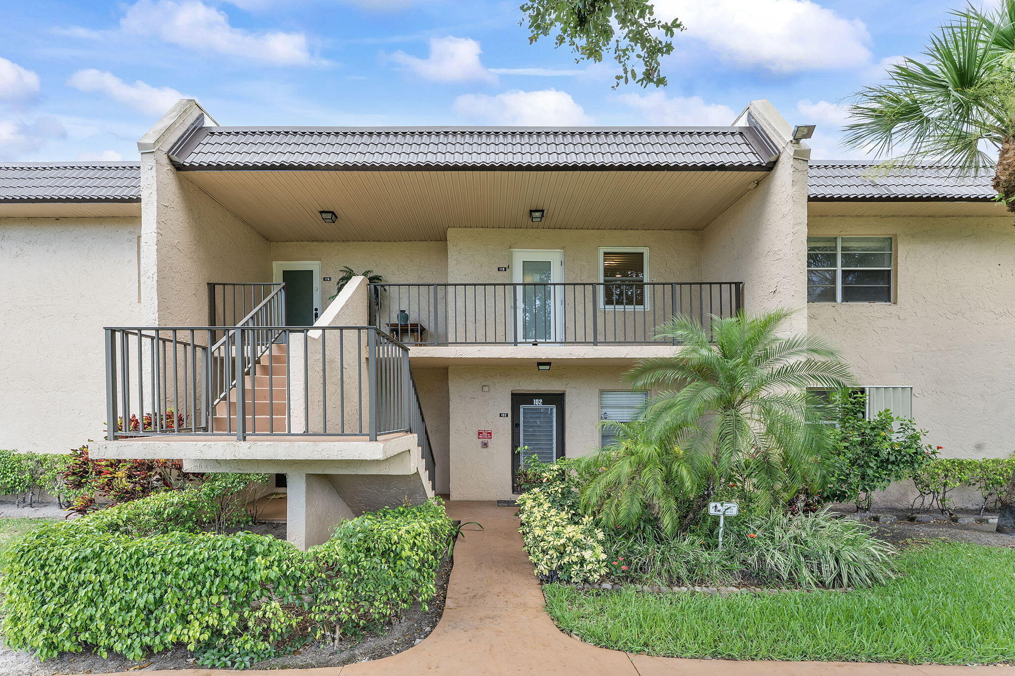 ** SELLER IS MOTIVATED** ** OPEN TO ALL OFFERS** This residence is completely renovated in 2024, features laminate and vinyl flooring, a spacious walk-in closet, and a kitchen equipped with stainless steel appliances. Enjoy serene lake and canal views from the private covered balcony. The unit is protected by impact glass storm windows. It is located within a secure, manned-gate community. This pet-friendly dwelling is part of a verified 55+ community (HOPA) and offers access to premium amenities, including a clubhouse, pool, sauna, tennis courts, and a courtesy bus. The monthly fee covers basic cable, water, sewer, trash, and exterior maintenance. No washer and Dryer in the unit. Common laundry facility available.