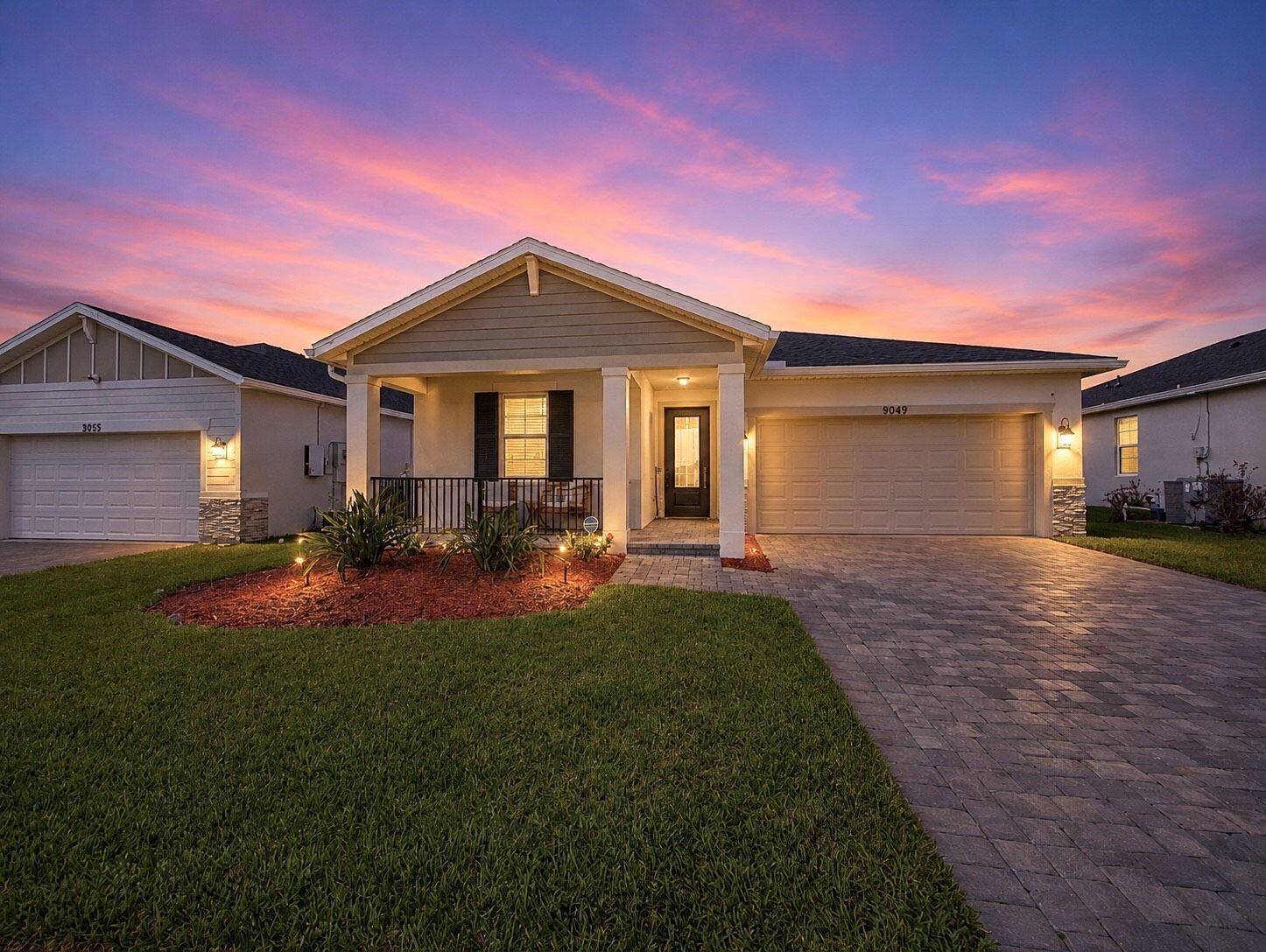 Discover exceptional comfort, efficiency, and modern style in this beautifully upgraded 4 bedroom and 2 bathroom Corsica model, located in the new community of Azalea at Tradition. The home features ceramic tile flooring throughout, premium quartz countertops in the kitchen and bathrooms, Category 5-rated impact-resistant windows, a Category 5-rated impact-resistant front entry door, and a climate-controlled, spray foam-insulated attic with an integrated dehumidification system. The thoughtfully designed kitchen is enhanced by upgraded brushed nickel faucets and plumbing fixtures, along with a convenient touchless faucet. Additional upgrades include a full-perimeter gutter system, built-in home security system, front door camera, keypad entry, and an epoxy-coated garage floor with a transferable five-year warranty. The open-concept floor plan creates a seamless flow between the kitchen, dining, and living areas, while four spacious bedrooms provide flexibility for family, guests, a private office, or flex space. Outside, the covered lanai and custom fire pit create an inviting setting for relaxing evenings, outdoor dining, and entertaining. A dedicated paver pad along the side of the home provides a clean and convenient storage area for trash and recycling containers.  Combining extensive upgrades, storm protection, energy-efficient features, and a desirable location within one of Tradition's newest communities, this move-in-ready home offers the best of modern Florida living.