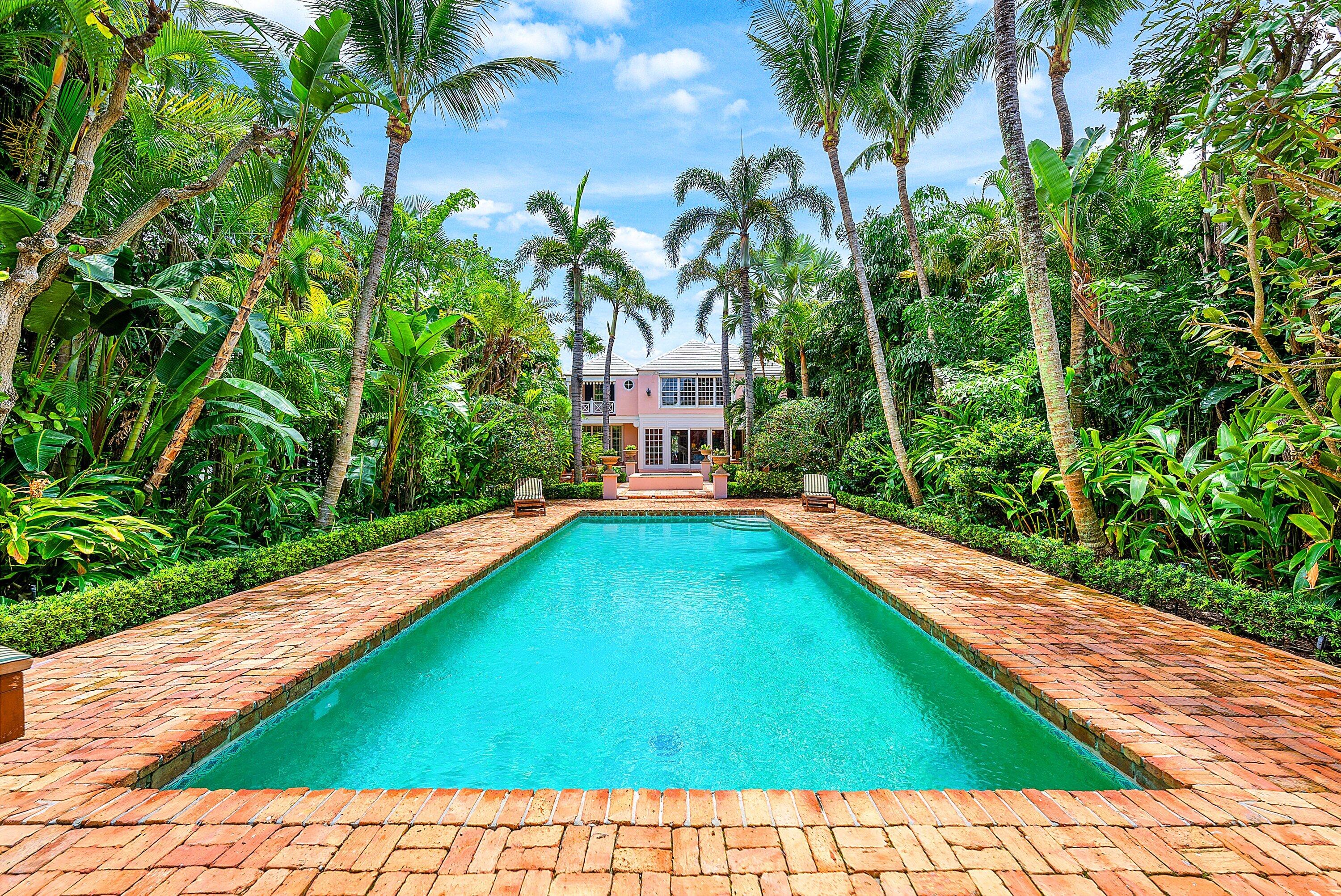 La Casa Rosada at 406 N Ocean Boulevard is a rare beachside estate in the heart of Delray Beach, offering an extraordinary combination of privacy, character, location, and unobstructed ocean views. Nestled behind lush tropical landscaping on a remarkably deep 350+ foot parcel, this timeless residence is just moments from the beach and Atlantic Avenue's acclaimed dining, shopping, and cultural attractions. The residence offers 3 bedrooms and 3.1 baths, including gracious living and entertaining spaces that open seamlessly to the gardens and pool. Additional flex spaces provide the opportunity to easily accommodate a fourth bedroom, office, library, or den, offering versatility to suit a variety of lifestyles.  Rich in architectural character and timeless appeal, the home presents a unique opportunity to enjoy as-is, thoughtfully enhance, or create a future legacy estate. Surrounded by mature palms and enchanting gardens, the property feels worlds away while remaining in one of Delray Beach's most desirable locations. Expansive brick terraces, tranquil water features, and a resort-style pool create a secluded outdoor sanctuary rarely found so close to the ocean. Adding to its appeal, the property is ideally positioned directly across from the ocean, where a uniquely private setting enhances the beautiful views and peaceful coastal ambiance. With exceptional ocean views, estate-sized grounds, unmatched privacy, and walkability to Atlantic Avenue, La Casa Rosada represents a truly rare offering in Delray Beach's coveted beach area.