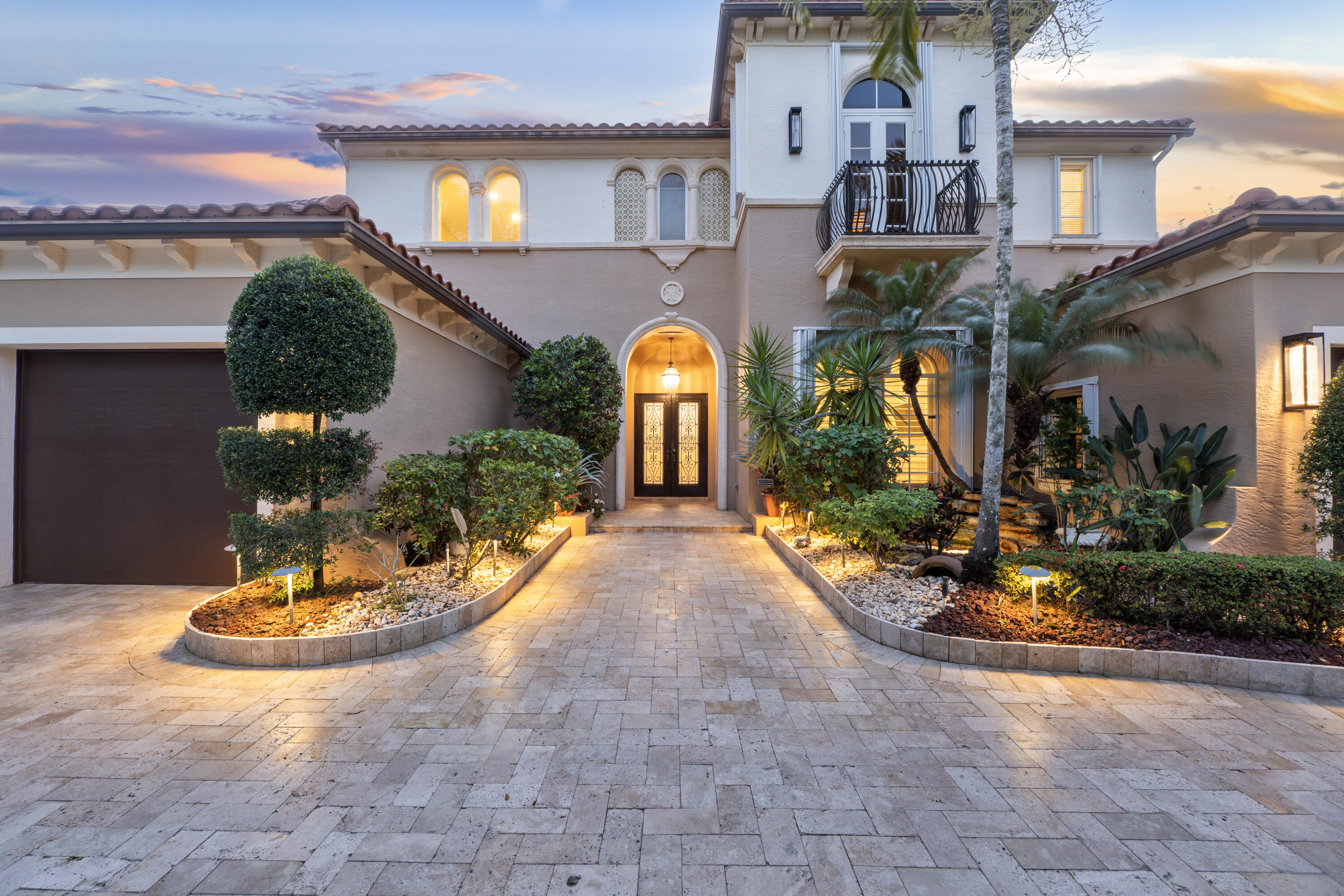 Experience elevated South Florida living in this fully remodeled custom built 6-bedroom, 6.5-bath lakefront estate in the prestigious double-gated subdivision "The Colony" at Heron Bay in Parkland. With coveted west-facing exposure, enjoy breathtaking sunset views. This home shows like a model, featuring soaring high ceilings and a seamless open layout. The first-floor primary suite offers dual bathrooms, double vanities, and spacious walk-in closets. The chef's kitchen includes upgraded appliances, including Sub-Zero refrigerator, wine cooler, and a gas range. Step outside to a resort-style backyard with a remodeled salt water heated pool and spa, summer kitchen, and lush tropical landscaping including a stunning canary palm. Complete with generator, accordion shutters, and low HOA fees.
