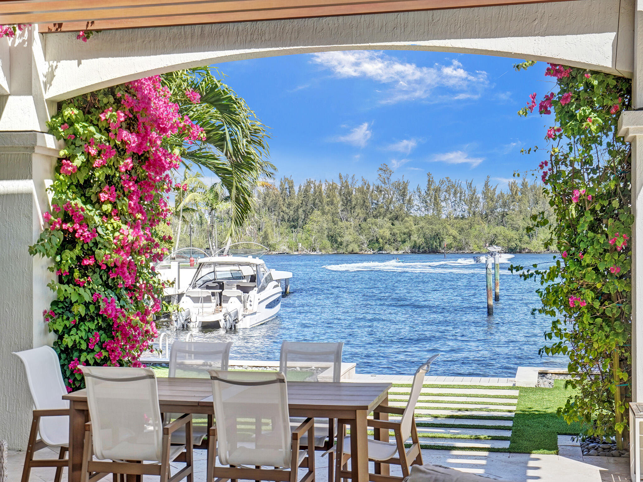 Finally a home that lives up to expectations. Absolutely amazing estate updated to perfection with stunning direct Intracoastal and park views. 4 Bedrooms plus fabulous Library w/Bath access. Located on an oversized corner lot w/floor to ceiling windows featuring Khars Swedish Grand Collection oil finish Rustic Maison Oak wood floors, Incredible custom kitchen with quartz counters, Calcutta Gold backsplash & Waterfall bar. Center Island with prep sink and walk in pantry. Wet bar with access to pool area & wine cooler. 1100 sf. 2nd floor Master Suite with sitting area & study/exercise area. Large walk in closet area. Balcony w/direct intracoastal views. The outdoors reflect lush landscaping, a 17 x 14 Loggia complete with gas grill, a uniquely designed pool & spa and dockage. Also, a tranquil "built in" fire pit within the pool.  New roof and gutter system, complete A/C, garage floor update and travertine paver driveway in 2023.  The private back yard view of the canal and intracoastal is breathtaking.  A TRUE MUST SEE!