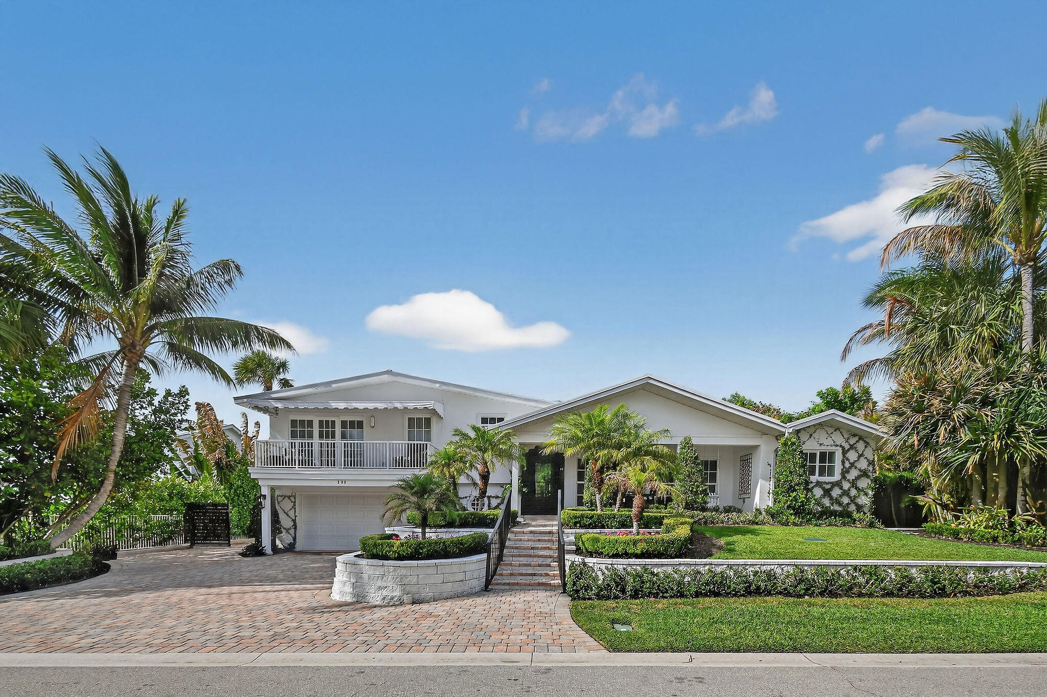 Tucked within the exclusive seaside community of Jupiter Inlet Colony at the southern tip of Jupiter Island, this fully renovated 4 bedroom, 4 bath home offers a blend of privacy, style, and effortless coastal living. Known for its quiet streets, private beach access, and dedicated police department, Jupiter Inlet Colony remains one of South Florida's most sought after enclaves. Fully renovated in 2024, the home is set on an elevated 10,450 square foot lot with no rear neighbors, surrounded by lush tropical landscaping and classic Palm Beach style espalier trellis walls. Its central in-town location places you just moments from both beach paths, making easy access to the ocean part of everyday life. Inside, a bright and open layout is enhanced by vaulted ceilings with exposed beams  and natural light flowing in from both sides. Impact rated windows and doors provide comfort and peace of mind, while the design balances a relaxed coastal feel with a clean, sophisticated finish. The outdoor setting is designed for both entertaining and quiet enjoyment, with a private pool and serene backdrop. Ample parking for up to seven vehicles offers added convenience for hosting guests. A stunning, move in ready residence in one of Jupiter's most desirable coastal communities.