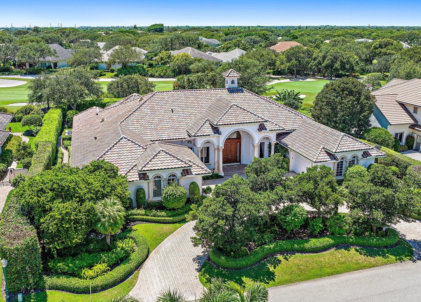 This spacious and beautifully appointed home located on the 16th hole of the Village Course at prestigious Jupiter Hills presents an opportunity to have that family compound you have been waiting for.  Enter a light filled formal living room that overlooks the beautifully landscaped pool and summer kitchen. The large kitchen-family room and adjacent theatre room will keep your family and friends entertained and happy.  A fully equipped theater room, and sumptuous paneled office complete the picture. The beautiful and calming master suite is the perfect place to begin and end the day. Three additional family bedrooms with ensuite baths and two powder rooms make this family home perfect for entertaining. The outdoor space is resort like and very spacious.  Large pool and jacuzzi as well as rock waterfall will be the back drop for family events for many years. The newer roof and impact rated doors and windows make this home a must have.