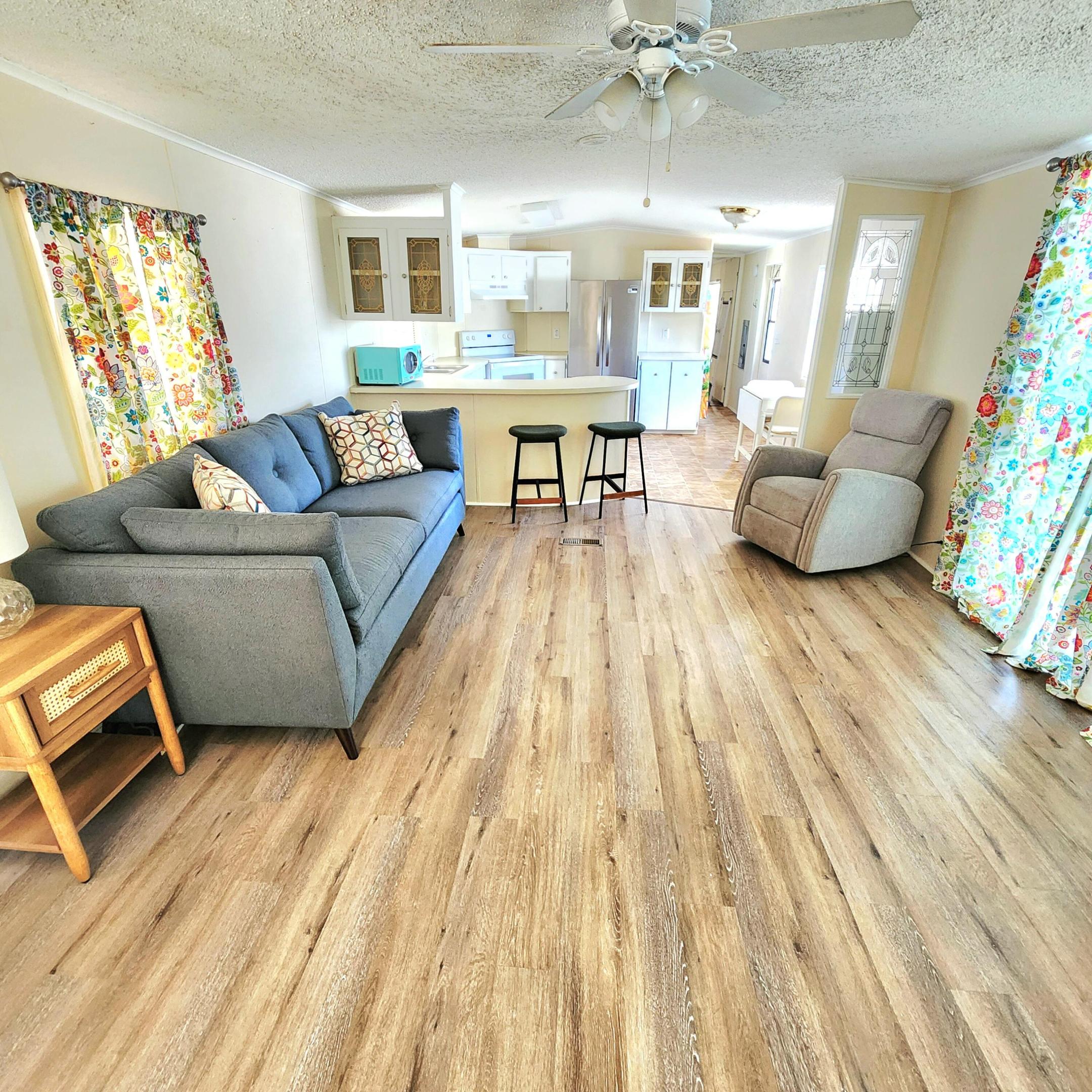 New Roof & Ready to Move In! THIS MUST SEE is PRICED TO SELL! Partially Furnished Charming 2 bed/2bath home nestled in a quiet 55+ community. Don't miss out on this deal! 2025 UPGRADES include NEW ROOF, Refrigerator, Washer/Dryer, Vinyl Flooring, Strapped CarPort & 2022 Vapor Barrier. Primary Bedroom boasts large walk-in closet & an ensuite w/ EXTRA storage.  Outdoor Screened Patio perfect for relaxing/grilling and more. Large Shed offers plenty of outdoor storage. Prime Location; near beach (NO FLOOD ZONE), grocery, bank, shopping, hospital, pharmacy, postal & more. Lot Lease 842.53 includes; Lawn,Trash,Security, Private Golf Course, Heated Pool, Fitness, Pickleball, Tennis, Shuffleboard, Bocce, Library, MahJong, BibleStudy, Workshop, Parades, Dinners, Dances & more!