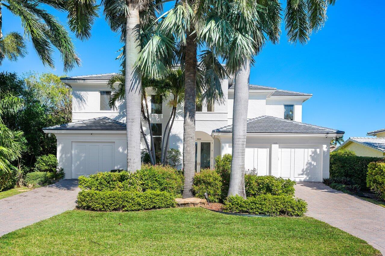 Welcome to 1021 Lewis Cove, a unique paradise for boaters, beach lovers, car enthusiast, or for those that simply enjoy light filled coastal living. Nestled on a fabulous waterfront lot on Delray Beach's prized barrier island, this home offers luxury, spectacular South Florida living and a walkable lifestyle, minutes to shops, grocery stores, restaurants and the beach! Walls of glass showcase incredible pool views from the open-concept living, dining, family room and kitchen, which are all proportioned for effortless entertaining indoors and out. A two story, light filled living room greets you as you enter. Beautiful travertine flooring, a built in bar, chef's kitchen, and guest suite round out the first floor. The beautiful warm wood and glass staircase take you upstairs to the dream master suite. Retreat and enjoy a spacious oasis that includes an exceptionally large bedroom and sitting area, large private balcony with water views, an impressive master bathroom with his and her vanities, separate spa tub and shower, a walk in sauna, wet bar with under counter refrigerator and sink, and two spacious walk in closets. Two more bedrooms, one with a Juliet balcony with tropical water views, and a spacious loft finish out your second floor. Enjoy the best of South Florida living together under the large covered patio complete with a built in summer kitchen. Situated on a wide canal, the new 2021 dock and 2009 seawall provide boating with ease. Store all your cars and toys in the 3 car garage. A 2021 roof, impact windows and doors, alarm system, cameras, and 3 AC units provide peace of mind and easy living. Conveniently located minutes from beach access, restaurants, grocery stores and a short distance from the Palm Beach and Fort Lauderdale International airports. This gorgeous waterfront home has it all.... amazing location and a superb floorpan in a lush, tropical setting.