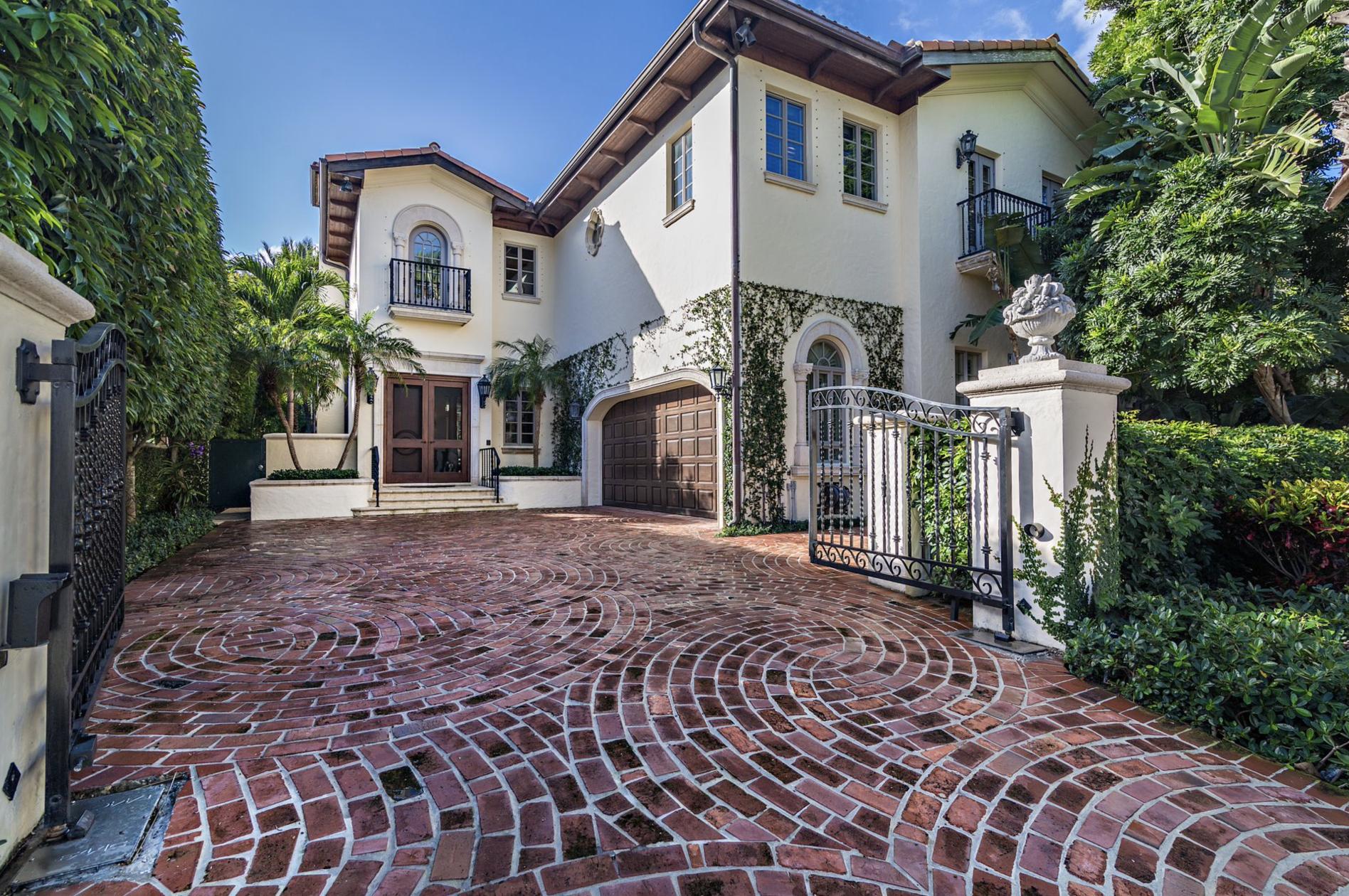 Prime in town location near shopping, fine dining, the beaches and town docks. This elegant 2 story Mediterranean townhome offers gracious entertainment rooms with 12' ceilings, French doors opening onto the pool and loggia offering indoor/outdoor living. Gardens designed by landscape architect Mario Never. Built in 1999 with over 5,200 total square feet. This home offers 3 bedrooms, 3.1 bathrooms, gated entry, 2 fireplaces, elevator, updated kitchen, and full house generator. Beautiful interior finishes and many improvements throughout. Gated privacy and lush gardens, this in-town townhome lives like a house but with the ease of a low maintenance townhouse.
