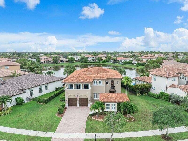 Incredible opportunity to own a 5-bedroom, 4-bathroom lakefront pool/spa home on an oversized, pie-shaped lot with a detached in-law suite boasting over 4,000 square feet of living area. HIGH VALUE UPDATES include a BRAND NEW ROOF, a new water heater, newer A/C's, freshly updated pool/spa setup complete with a child-safety gate and fenced yard. Property has been freshly painted inside & out, Large lot with pristine landscaping. Impact windows & doors in most areas, and accordion shutters on the rest. Inside, you will find an upgraded kitchen w/high-end wood cabinets, Oversized island w/porcelain countertops, and stainless steel appliances, Additional amenities include a screened lanai.  Resort-Style Heron Bay Amenities Include 2 Clubhouses, Pools, Tennis, Fitness Centers & A-Rated Schools Experience resort-style living every day at Heron Bay, where luxury amenities meet an active, vibrant lifestyle. This premier community boasts two beautifully upgraded clubhouses designed to serve as the ultimate social and fitness hubs for all ages.    Plaza Del Lago: Family & Relaxation Brand-New Waterpark: High-energy splash park perfect for children. Resort Pool & Spa: Heated swimming pools paired with saunas and steam rooms. Modern Wellness: State-of-the-art fitness center with upgraded interiors.   The Commons: Sports & Athletics Elite Racquet Facilities: 12 clay courts, 1 hard court, and 6 brand-new pickleball courts. Athletic Center: Fully equipped gyms and aerobics spaces. Full Amenities: Dedicated men's and women's locker rooms for post-workout transitions.   Seamless Community Access Golf-Cart Friendly: Easily cruise between both clubhouses. Active Trails: Reach any amenity via scenic walking and biking paths. Ultimate Convenience: Fully accessible by car with ample parking.