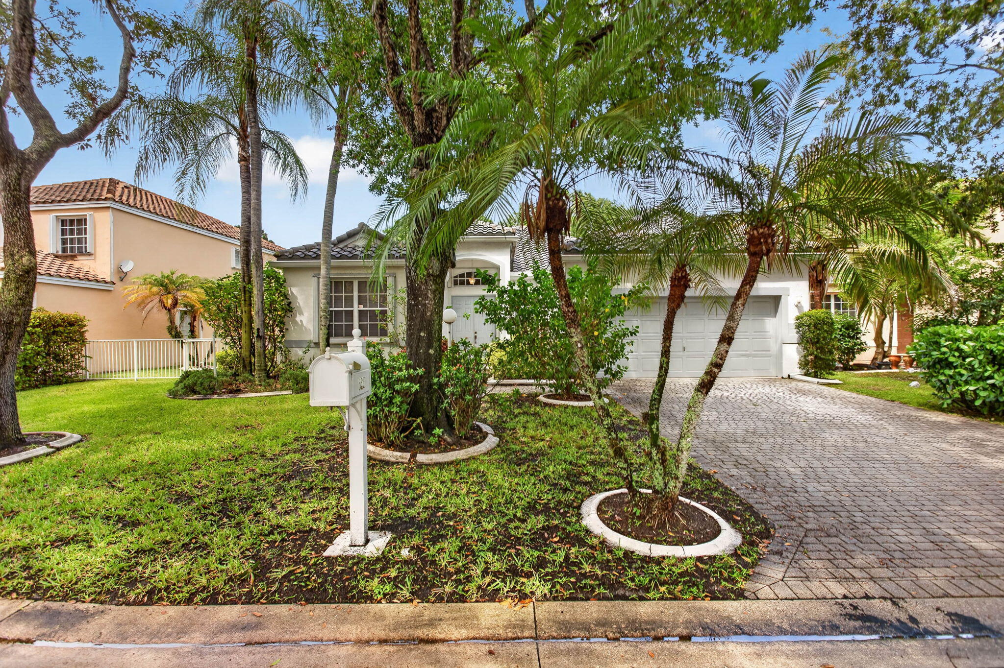 Welcome to this spacious one-story home offering 3 bedrooms, 2.5 bathrooms, and a versatile room/office overlooking the water. Featuring vaulted and volume ceilings, this well-maintained residence offers an open living and dining area with a desirable split floor plan. Enjoy Florida living from the fenced backyard with a paver patio overlooking the water. Additional highlights include accordion hurricane shutters throughout, a newer A/C unit approximately 3 years old, and a barrel tile roof installed in 2018.
