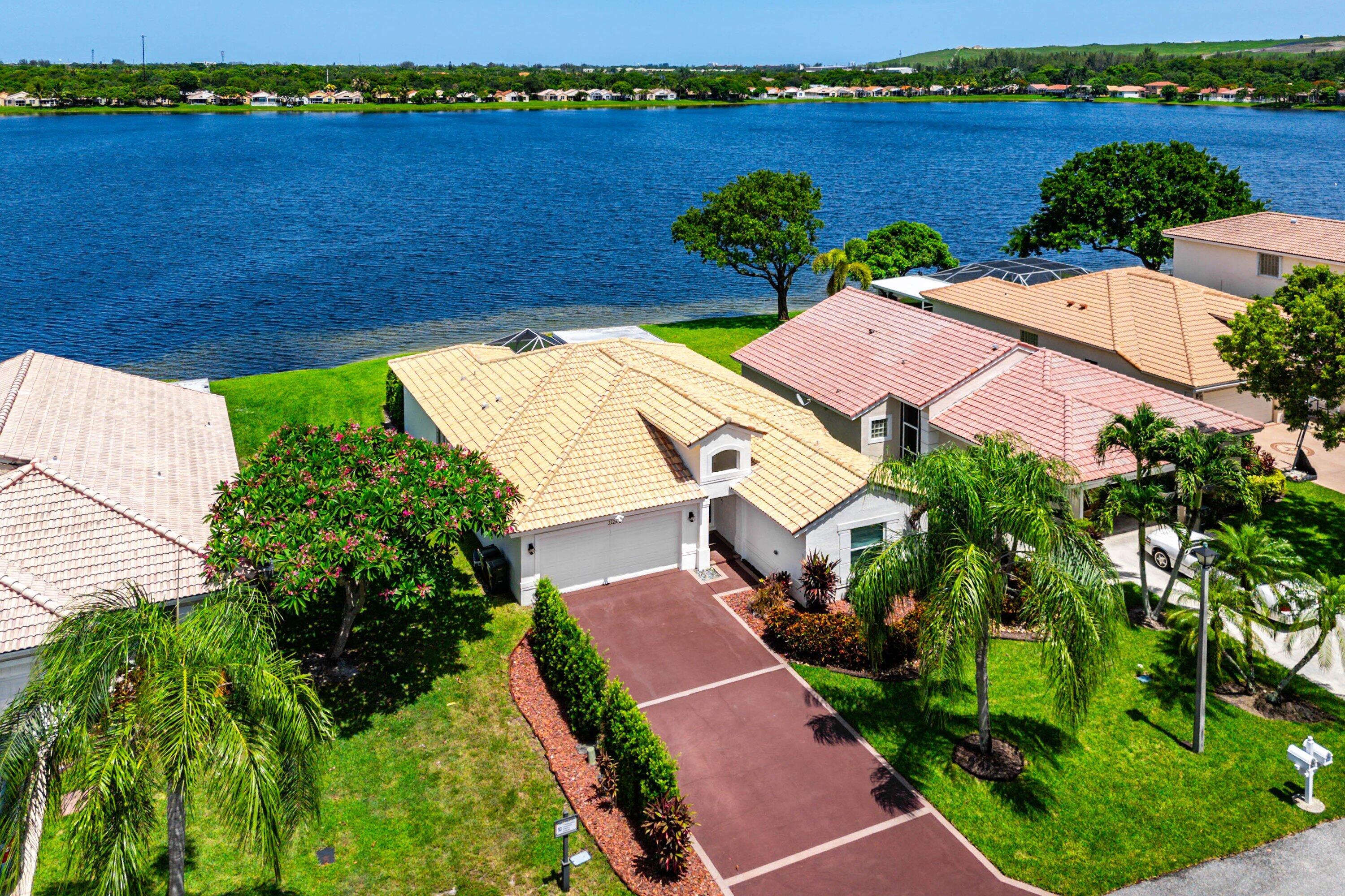 Welcome to your own waterfront retreat in the highly desirable Coco Lakes community of Coconut Creek. This friendly neighborhood offers the perfect blend of tranquility and convenience, just minutes from The Promenade at Coconut Creek, Sabal Pines Park, shopping, dining, and easy access to I-95 and Florida's Turnpike.  Bright, elegant, and beautifully remodeled, this stunning lakefront home showcases breathtaking water views from the backyard, living room, kitchen, and primary bedroom. Soft white tones, soaring ceilings, and abundant natural light create a fresh, inviting atmosphere that feels like a luxury getaway every day...  The open-concept kitchen is the heart of the home, featuring quartz countertops, tall bamboo-inspired cabinetry, premium finishes, and seamless flow into the spacious great room—perfect for entertaining or everyday living.  Wake up to spectacular sunrises over the lake from the comfort of your primary suite, where peaceful water views create the perfect start to every day.  Complete with impact windows and doors and a 2020 roof, this impeccable, move-in-ready home is the perfect combination of style, comfort, and location.