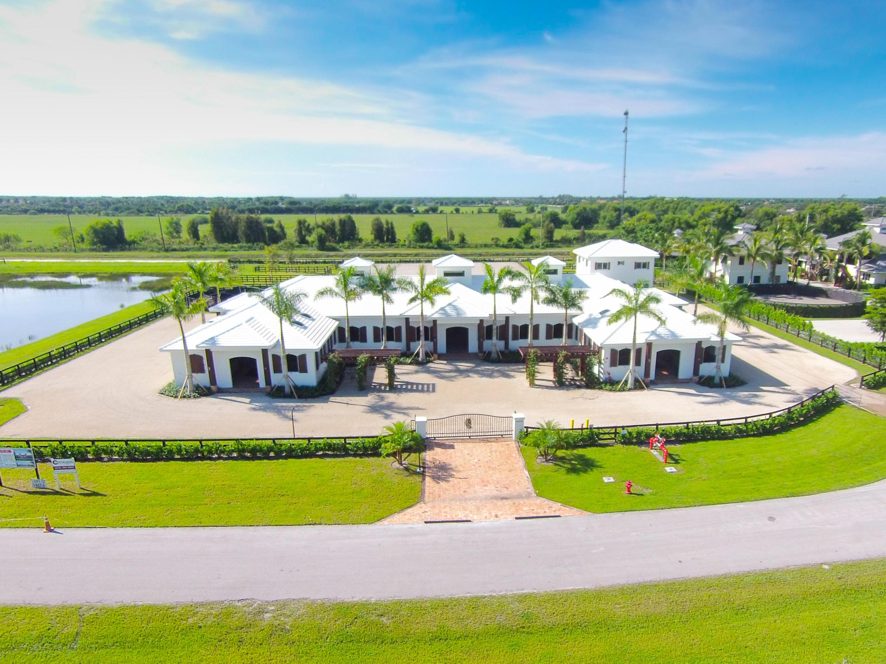 Sunset West Farm is a spectacular 4 acre equestrian facility that features a twenty-six stall stable, three bedroom staff apartment, six paddocks, an all weather ring and a five-horse walker. A gated driveway entrance welcomes you to the property with ample parking space. The twenty-six stall stable, finished with the finest building materials, includes two tack rooms, two feed rooms, two laundry rooms, four grooming/wash stalls, a lounge with private full bath, office and powder bath. The stalls are 12' x 12' and include 3/4''' rubber mats, sliding stall doors, arched exterior windows, and Oasis paddle fans. The ceilings over the stalls and stable aisles are finished with tongue and groove v-joint pine and showcase a large chandelier at the center of the stable and two smaller chandeliers in the aisles. Hurricane proof roll-up doors at seven stable exits and colonial shutters at all stall window openings ensure added safety and security. The stable is fly spray system complete and includes nozzles in ceilings, all stalls and stable aisles with the tank located in the feed room.

A separate two story building on the property includes a garage on the first floor. The second floor grooms apartment offers three bedrooms, two and a half baths, full kitchen, and ceramic tile throughout.

The 135' x 220' all weather jump ring is finished with Martin-Collins footing. Six paddocks with three-rail wood fencing are located throughout the property. The full lot automatic sprinkler system provides complete coverage of the property and includes six water cannons covering the jump ring.