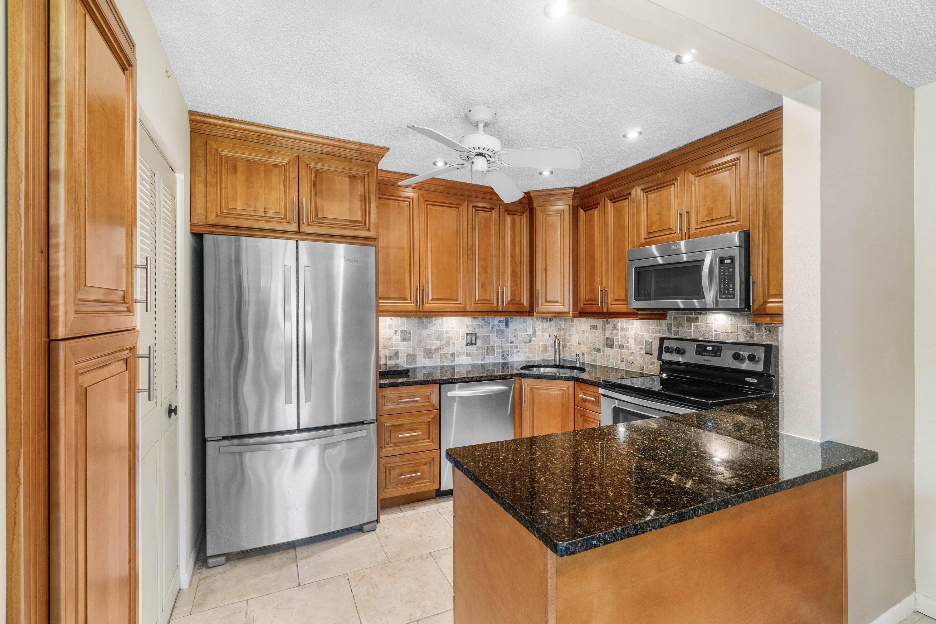 Owner Financing Available. All Offers Are Welcomed...  Fully Renovated 2BR 1 1/2 BTH Condo Nestled In An Active 55+ Community. Convenient Parking At Front Door.. Screened In Lanai W/ Storage Closet.  Condo Has New Roof 2024, Complete Hurricane Windows, Tankless Hot Water Heater, New Electrical Box, Stunning Tile Thru-Out, Fabulous Kitchen W/Granite Counter Tops, Full Height Wood Cabinets, Extra Pantry,S/S Appliances,   Full Laundry Room, Off Kitchen Which Is Convenient, Large Walk In Closet In Both BRS. Low Low Low Hoa 433.00 per month Which Includes..Wi-Fi..Cable. Common Grounds..Building Insurance..On Site Management.. Enjoy All The Amenities.. Clubhouse, Oversized Heated Pool, Pickle Ball,Tennis,Bocce, Shuffleboard.  Come See Your New Home