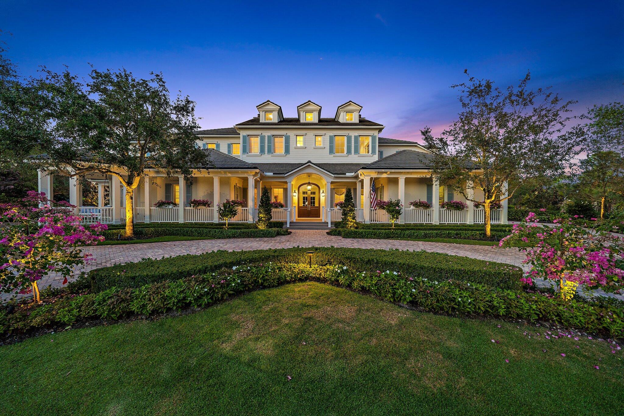 This exquisitely beautiful home tucked away within the intimate gated community of Old Marsh Golf Club is one of the best kept secrets in the area! Surrounded by scenic nature preserves, lakes and golf course views, this tailor fit home was recently renovated by the elite custom home builder, Turtle Beach Construction. 
This masterpiece was originally built in 2014 by Maxwell Construction, blending Edgartown and Augusta architecture featuring three stories, multiple outdoor porches, open kitchen, and family rooms, two primary suites, a wine room, two offices, Lutron lighting, brand new flooring throughout and the expansive backyard features the large swimming pool and views of championship golf course. The list of upgrades are endless at this breathtaking estate! Old Marsh offers 180 half-acre home sites with marsh, lake, or golf course views. All the residences here are custom estate homes and many are situated on two or three lots. The championship golf course was designed by the highly acclaimed architect Pete Dye and consistently has been ranked one of the best courses in the United States. Old Marsh Golf Club, with its newly renovated clubhouse, decorated in rich dark woods and comfortable fabrics that create a warm and friendly atmosphere, continues to preserve the true traditions of golf. Here, no starting times are required, and a nationally acclaimed caddy program enriches your experience on the course. Old Marsh Golf Club is recognized as one of the top 35 private clubs in the country and Audubon International awarded it certification for its environmentally enhancing design and maintenance. Birds, fish, and other wildlife abound at Old Marsh, yet it is still just minutes from all the shopping, dining, and entertainment venues of the Northern Palm Beaches. The Gardens Mall is but a short drive away, as is the Intracoastal, the Atlantic Ocean, Worth Avenue, City Place, the Kravis Center, many fine public and private schools, and the Palm Beach International Airport.