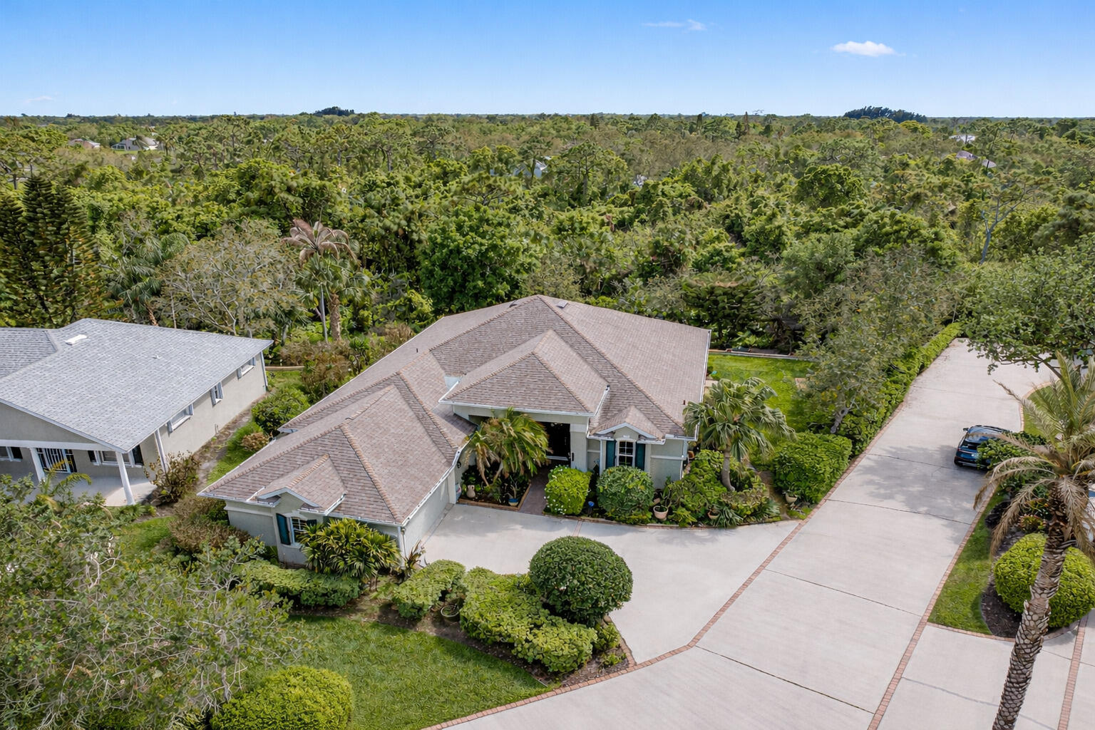 First time available--rare opportunity. Original owners selling.  Spacious 3/2 with den, split BR plan with amazing 35X9 glassed in porch overlooking private, back terraced yard with tiered patios.  Larger 22.4X20.4 garage, separate laundry room.   Volume ceilings, crown moldings, newer 2022 roof, tile, wood and laminate flooring. Complete set of accordion shutters plus automatic roll down shutters in front.  Lawn sprinkler on well.  Botanical gardens and privacy hedges enhance the grounds.  No age restrictions in this gated golf community.  Great clubhouse with fitness room, large pool and activities.   Owner occupied.