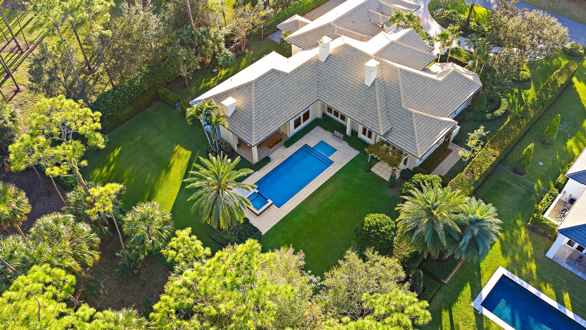 Welcome to 12900 Hammock Crossing, a stunning retreat nestled in the heart of Palm Beach Gardens. This exquisite 4 bed/5.5 bath property is a harmonious blend of timeless elegance and modern luxury, offering a lifestyle that's second to none.Situated in the exclusive gated community of Old Marsh Golf Club and located on the Par 3 16th hole, this residence boasts unparalleled privacy. The home features an expansive, open-concept layout perfect for entertaining, with soaring ceilings, abundant natural light, and impeccable craftsmanship throughout.Outside, the lushly landscaped grounds are home to a spacious yard, heated salt water chlorinated pool and spa, covered lanai with summer kitchen, and plenty of space for al fresco dining or simply enjoying the covered outdoor living - complete... ...complete with fireplace, bar, and electronic screens.  As part of Old Marsh, residents enjoy a world-class club, including a Pete Dye championship golf course, no tee times, and a renowned caddie program. All of this just minutes from the Palm Beach International Airport, 5-Star dining, renowned shopping and beautiful blue beaches.  This is more than just a home it's a lifestyle. Don't miss your opportunity to experience the perfect blend of sophistication, comfort, and nature.