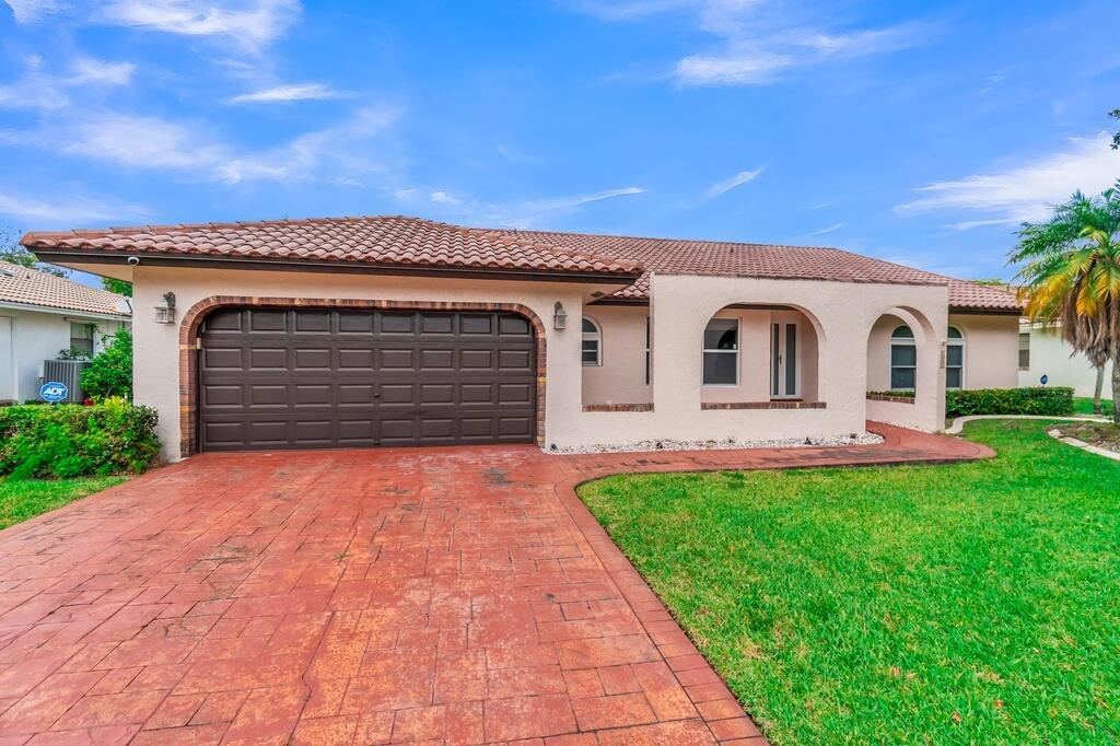 Well-maintained 4-bed, 2.5-bath home in Cypress Lakes, one of Coral Springs' most sought-after neighborhoods - zoned for excellent schools & situated on a 9440 SF lot w/ functional floor plan. The custom kitchen features real wood cabinetry, granite countertops, stainless steel appliances, breakfast nook, & full-size drawers for pots/pans opening seamlessly to the main living and dining areas. Neutral tile flooring flows throughout the entire home for easy maintenance. The spacious primary suite features direct patio access. Step outside to a screened-in pergola, large pool, & fully fenced backyard designed for year-round South Florida outdoor living & entertaining. Conveniently located near parks, shopping, dining, & major highways, this home offers size, upgrades, location, & lifestyle.
