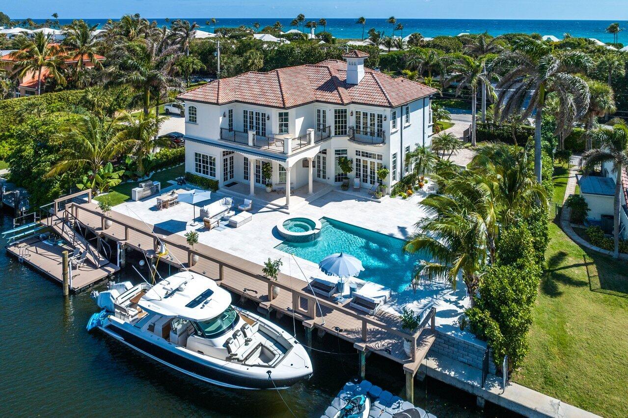Nestled along the pristine shores of Ocean Ridge this home presents a rare opportunity for luxurious intracoastal and beach living. This meticulously designed residence with 5 bedrooms, an office/gym and 6 full and 2 half baths is situated on an impressive lot boasting 115 feet on the water, offers an expansive waterfront experience. The thoughtful design ensures breathtaking waterfront views from almost every room in the home, creating a seamless connection between indoor living spaces and the stunning surroundings.

Inside features extensive custom millwork, teak built-ins, an eat-in kitchen, and airy coastal vibes throughout, with nice touches of chrome fixtures to give you that coastal, nautical feel. The heart of the home, the gourmet kitchen, is a culinary masterpiece featuring state-of-the-art appliances, custom cabinetry, and a generous island. Designed to accommodate both intimate family gatherings and grand entertaining, this space opens onto a brand new summer kitchen, extending the living area outdoors. Stepping into the private oasis, the lushly landscaped yard meets a picturesque backdrop for the waterfront terrace and pool area. With a brand new dock and floating dock, this residence caters to both boating enthusiasts and those seeking a tranquil retreat. The brand new retractable awning ensures year-round enjoyment of the outdoor spaces. The home also features an elevator from the main level sitting area to the upstairs living room. The home is equipped with 2 in-ground propane tanks, gas range and generator. The side yard features a secluded garden area with a cold plunge and outdoor shower. 

The master suite is a oasis that must be seen to be appreciated. As you open the double doors you are greeted by custom built-in shelving, the spacious master bedroom with amazing views of your backyard and water. The bathroom is divided into his and hers with separate vanities, closets, a floating tub and a shared shower enclosure to connect the two bathrooms. To top it off the master has a massive wrap around patio overlooking the water and your backyard paradise. 

Adding to the allure of this home, the backyard boasts a coveted southwest exposure, ensuring that your private oasis and pool receive abundant sunshine throughout the year. This sought-after orientation allows you to bask in the warmth of the sun, creating an inviting outdoor haven for relaxation, entertainment, and rejuvenation. Whether you're enjoying a leisurely swim, lounging by the poolside, or hosting gatherings in the beautifully landscaped yard, the southwest exposure ensures that your outdoor spaces are bathed in sunlight, creating a tranquil and inviting atmosphere.

Adding to the practicality of this coastal haven, the home features a laundry room both upstairs and downstairs, providing convenience and flexibility for the homeowner and staff. For added convenience and security, the property includes a 2-car garage and a secure, gated motor court, offering privacy and ease of access. This home also comes with exclusive access to the beautiful McCormick Mile Beach Club, a private gated clubhouse and beach within walking distance (1/2 mile.) Whether you choose to stroll or drive your car or golf cart, ample parking at the club ensures a seamless transition to the sun-drenched shores in just moments. The Ocean Ridge public beach is just 400 yards from the house making it an easy stroll to the sand. 

Schedule a private viewing to fully appreciate the exceptional features and unmatched charm of this oceanfront masterpiece. Serious inquiries and qualified buyers are invited to explore the unique coastal luxury that awaits.