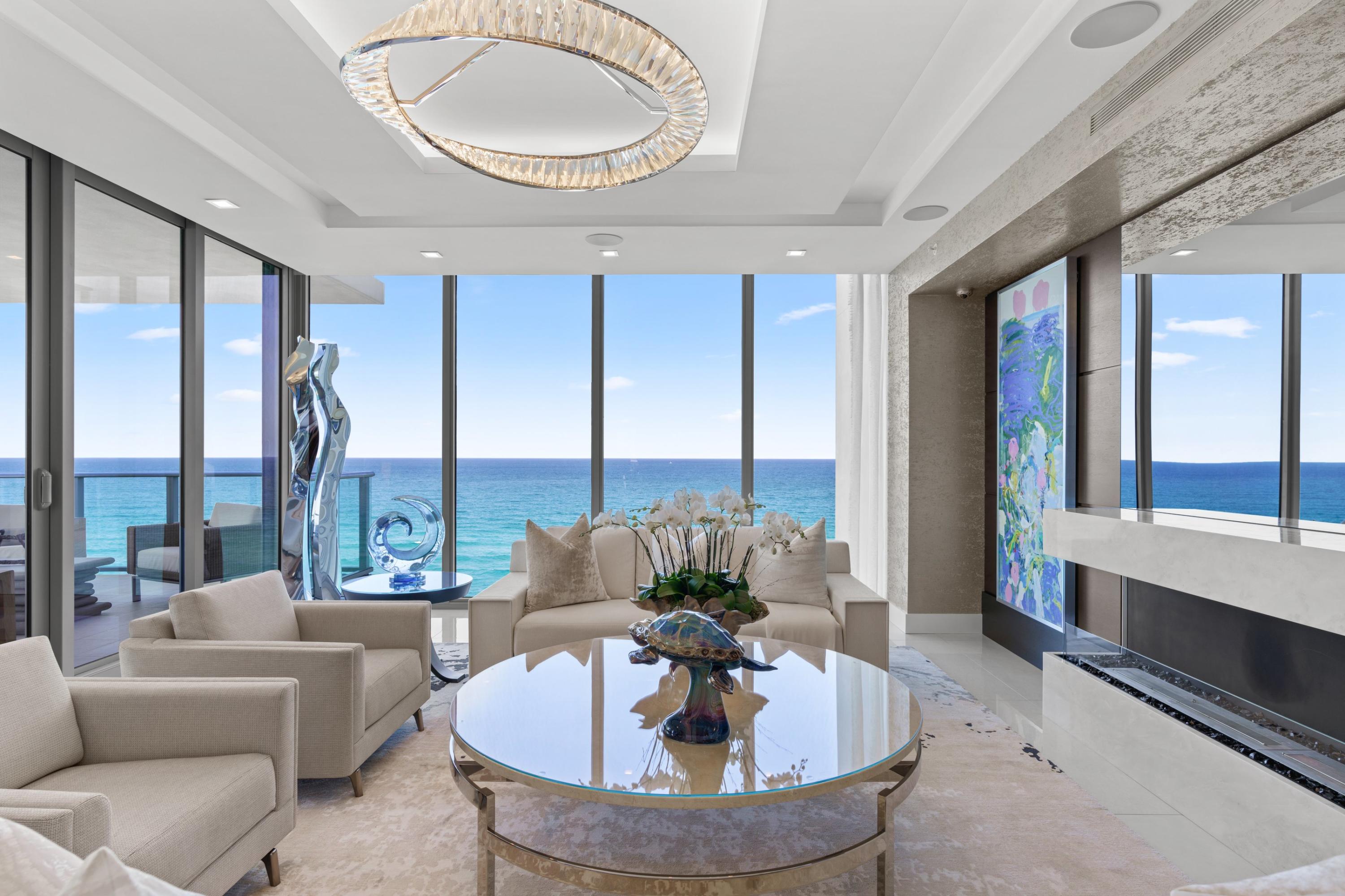 The perfect combination of fire and water in this entirely elevated piece of paradise in the sky.  A once in a lifetime opportunity to own the most distinctive home in the brand new 5000 North Ocean.  This exceptional residence boasts nearly 4000 square feet of custom finishes, showcasing architectural floor to ceiling windows in every room.  Wake up to the endless views and crashing waves of the Atlantic Ocean, or enjoy an evening cocktail from your den while watching the sunset over the Intracoastal as you listen to your self playing piano. The entire residence is controlled by a smart home integrated system including audio, video, custom TV's in the bathroom and Living room mirrors, as well as electric shades in every room. This residence is custom designed by Rogers Design Group, so it's sure to impress from the moment you enter through your private elevator foyer.  Custom wood entry doors and paneling, curated artwork and pieces, custom lit and built closets, even hideaway patio screens on your sliding doors.  Attention to detail is everywhere, and there is no corner untouched in this one of a kind masterpiece. Furniture was carefully designed for the space and is included for the next owners ease of ownership. 5000 North Ocean, the newest place to call home on Singer Island, is a boutique ultra-luxury building featuring a state of the art fitness center, beautifully designed clubroom, custom designed pool as well as a 24 hour concierges and manned gate. 5000 N Ocean's beachfront location and unique amenities are sure to welcome you home.  This is luxury modern living at its finest.