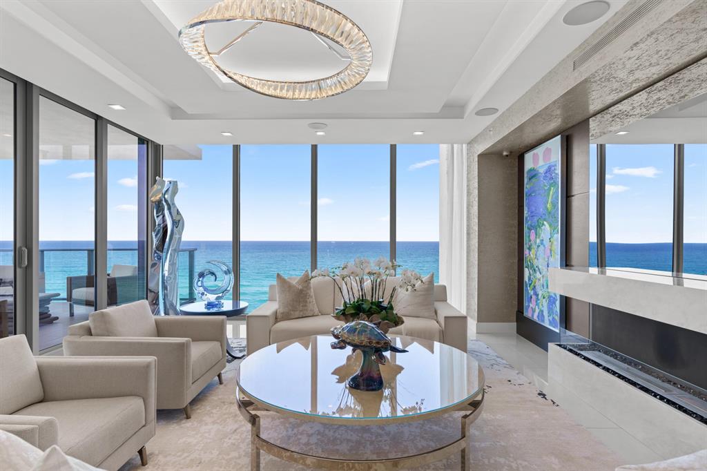 The perfect combination of fire and water in this entirely elevated piece of paradise in the sky.  A once in a lifetime opportunity to own the most distinctive home in the brand new 5000 North Ocean.  This exceptional residence boasts nearly 4000 square feet of custom finishes, showcasing architectural floor to ceiling windows in every room.  Wake up to the endless views and crashing waves of the Atlantic Ocean, or enjoy an evening cocktail from your den while watching the sunset over the Intracoastal as you listen to your self playing piano. The entire residence is controlled by a smart home integrated system including audio, video, custom TV's in the bathroom and Living room mirrors, as well as electric shades in every room. This residence is custom designed by Rogers Design Group, so it's sure to impress from the moment you enter through your private elevator foyer.  Custom wood entry doors and paneling, curated artwork and pieces, custom lit and built closets, even hideaway patio screens on your sliding doors.  Attention to detail is everywhere, and there is no corner untouched in this one of a kind masterpiece. Furniture was carefully designed for the space and is included for the next owners ease of ownership. 5000 North Ocean, the newest place to call home on Singer Island, is a boutique ultra-luxury building featuring a state of the art fitness center, beautifully designed clubroom, custom designed pool as well as a 24 hour concierges and manned gate. 5000 N Ocean's beachfront location and unique amenities are sure to welcome you home.  This is luxury modern living at its finest.