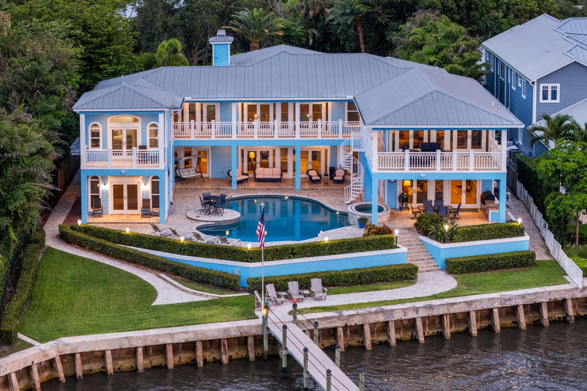 Located on coveted Riverside Dr near downtown Stuart, this waterfront estate blends timeless design with modern luxury. With 5 beds, 5.5 baths, and over 6,700 total sq/ft, it offers 115+ feet of wide waterfront views, a seawall, and a renovated dock with dual lifts (24k & 13k lbs). A private in-law suite supports multigenerational living. Resort-style outdoor living features a oversized heated pool/spa, covered patio, outdoor shower, built-in gas grill, and oversized balconies overlooking the St. Lucie River. The setting offers exceptional privacyyou only see neighbors when you want to. Inside: Sub-Zero & Viking appliances, SONOS, Ring, impact windows/doors, epoxy-finished 3-car garage, a 1,000-gal propane tank powering the whole-house generator, and a 500-gal tank fueling the gas appliancesall delivering the ultimate in turnkey coastal living.