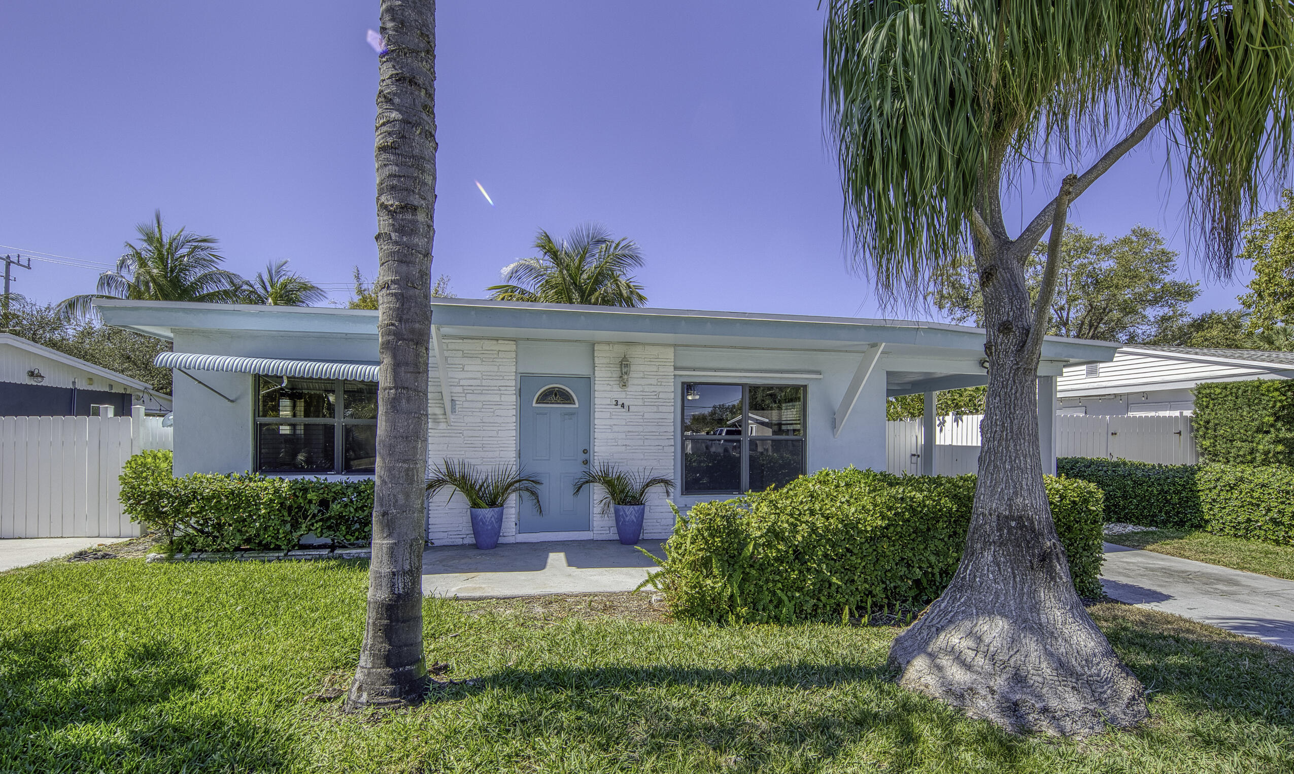 Walk to Ocean Ave shops, restaurants and the Beach!  1950's, Adorable 2/1, CBS construction home has loads of storage, carport (that would make a killer primary or in-law suite) and plenty of room to build out whatever you've been dreaming of!   The huge, fully fenced backyard with mature mango and fruit trees, can fit a pool, ADU and has plenty of space for kids and fur babies to run and play.  Fully enclosed porch offers 180 more square feet of air conditioned comfort. Perfect as a family room or extra BR.   Original features include Terrazzo floors, dade county pine, pecky cypress and handcrafted cedar.  Your extra touches can turn this into a real showstopper!