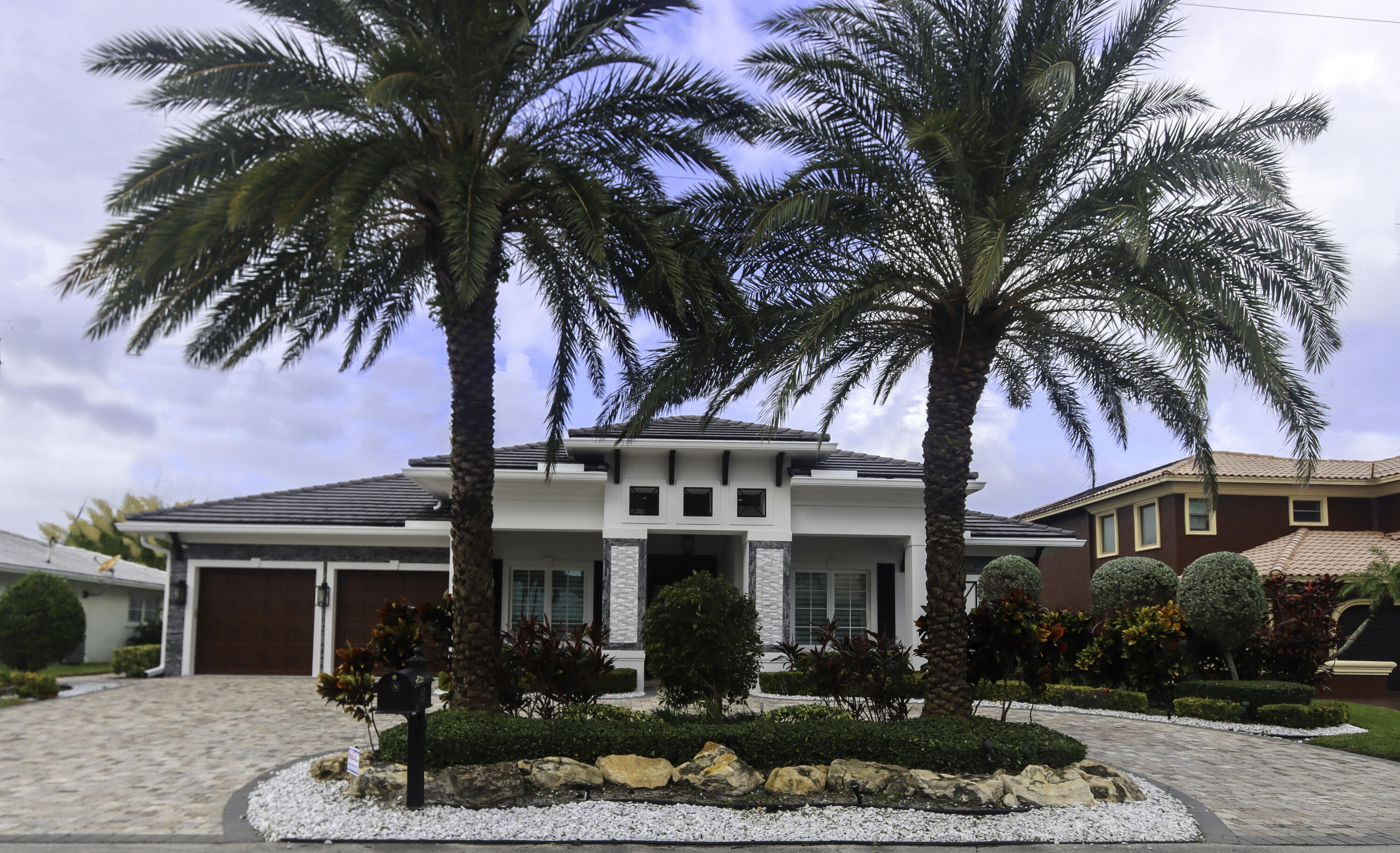 Experience luxury living in this rarely available custom turn-key waterfront home built by Boca Estate Builders. Located in East Boca Raton on a deepwater ocean access canal with no fixed bridges and 85 ft of prime dockage. This like new 3 bedroom, 4.5 bath home also includes a den that could be 4th bedroom. Elegant details include a chef's kitchen equipped with Thermador appliances, 12 ft high ceilings, wainscoting, crown moldings and more. Expansive kitchen island seamlessly connects with the open living and family rooms and dining area, all with amazing water views. Enjoy smart home technology, surround sound, impact glass, and generator. Outside includes heated pool and spa alongside a fully equipped summer kitchen providing the perfect retreat for relaxation or entertaining.