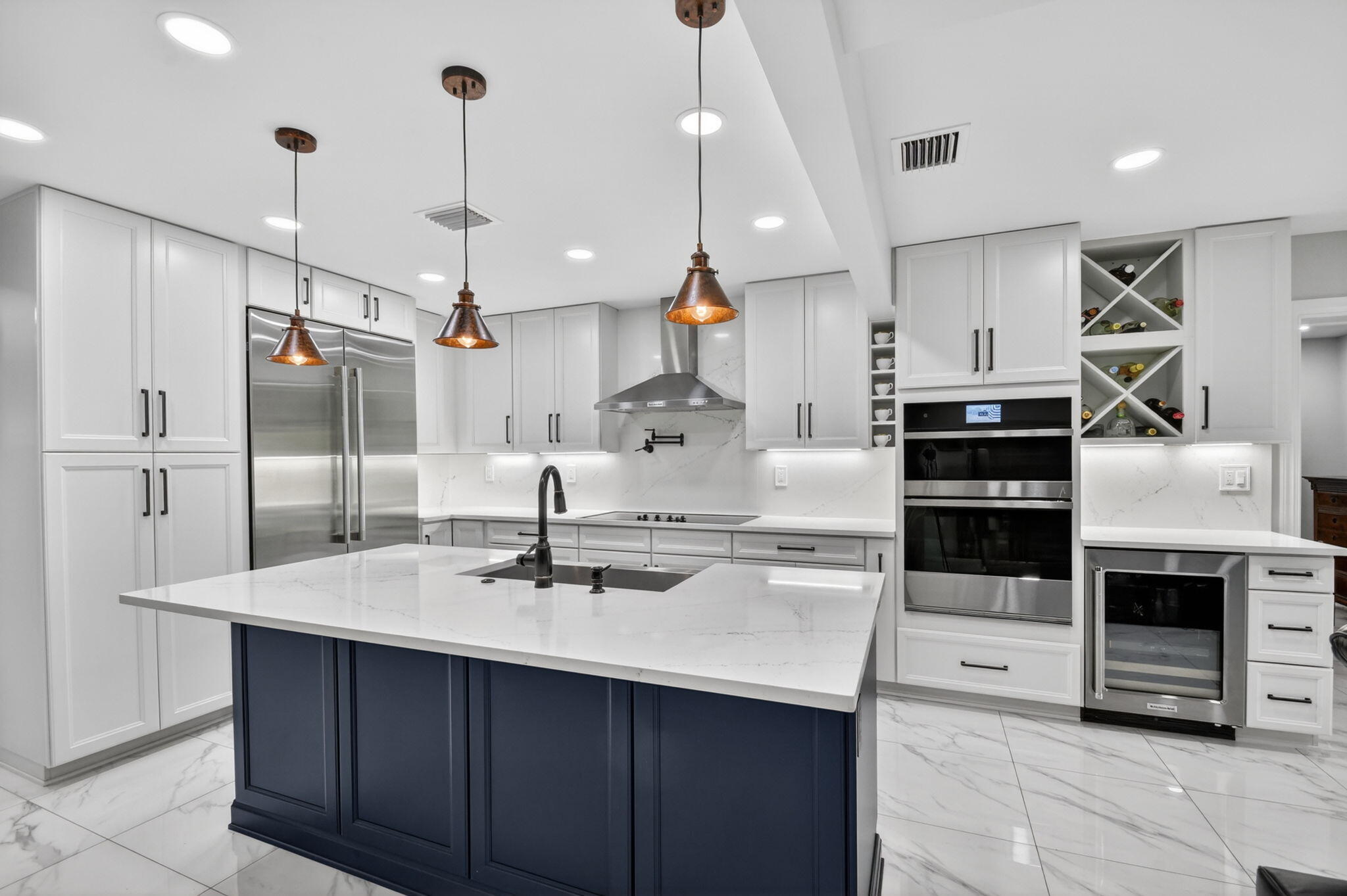 Completely reimagined from top to bottom with exceptional craftsmanship and attention to detail, this stunning waterfront residence offers the feel of brand-new construction with every major system thoughtfully upgraded. Featuring 5 bedrooms and 3.5 bathrooms, this turnkey home boasts a new roof, hurricane impact windows, new electrical, plumbing, AC systems with ductwork, spray foam attic insulation, exterior stucco finish, gutters, irrigation system and more. Situated on a navigable canal with a private boat/jet ski ramp, this property delivers the ultimate South Florida lifestyle—all with NO HOA. The designer chef's kitchen showcases premium JennAir counter-depth refrigeration, JennAir built-in wall oven and microwave combination, Thermador cooktop, KitchenAid 36-inch canopy hood & dishwasher, 36-inch Kohler stainless steel farmhouse sink, pot filler, 42-inch upper cabinetry, oversized built-in pantry, full-height backsplash, under-cabinet lighting, pull-out spice organizer, lazy Susan and an oversized island with built-in recycling and trash storage. A custom wet bar with wine cooler and wine storage enhances the home's entertaining appeal. Luxury finishes are found throughout, including beach-entry frameless showers, custom drop soffit ceilings with crown molding, solid-core shaker doors, designer lighting, color-changing LED recessed lighting with dimmers, skylight, oversized baseboards and custom millwork. The tiled panoramic screened lanai and open patio is prepped for outdoor kitchen with electrical plus hot and cold water connections. The tropical backyard feels like a private resort with lush landscaping and mature mango, coconut, pineapple, soursop and plantain trees. Additional highlights include a 2-car garage, oversized driveway with parking for up to 8 vehicles, dedicated boat, trailer and RV parking, RV electrical hookup, EV charger, tankless water heater and MyQ smart garage system. Conveniently located near Palm Beach International Airport, downtown West Palm Beach, major highways, shopping, dining and area beaches, this rare turnkey waterfront property offers luxury, functionality and peace of mind in one exceptional package.