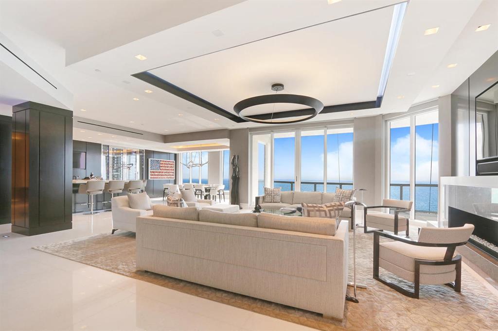 Breathtaking direct ocean views from this beautifully appointed, spacious penthouse apartment.  The direct ocean views are viewed from the living room, dining room great room and kitchen. The water views expand to include the Intracoastal to the north and west. The penthouse lives like an oasis with a pallet of white and light silver gray and custom features adorning the entire unit including marble and walnut finishes plus custom lighting. The expansive north balcony features a spa and fountains as well as sitting areas and a full outdoor kitchen and bar.  The interior features include Creston and Lutron system, built-in speakers, refrigerator drawers, warming drawers, built-in Miele coffee-expresso maker, ice maker in the bar and security cameras. The listing also includes Garage Parking Spaces G2 325, G2 326, G2 327 & G2 328 plus Storage Space 2A.  The building has a full time manager, doorman, valet, movie theater, social room and restaurant.
