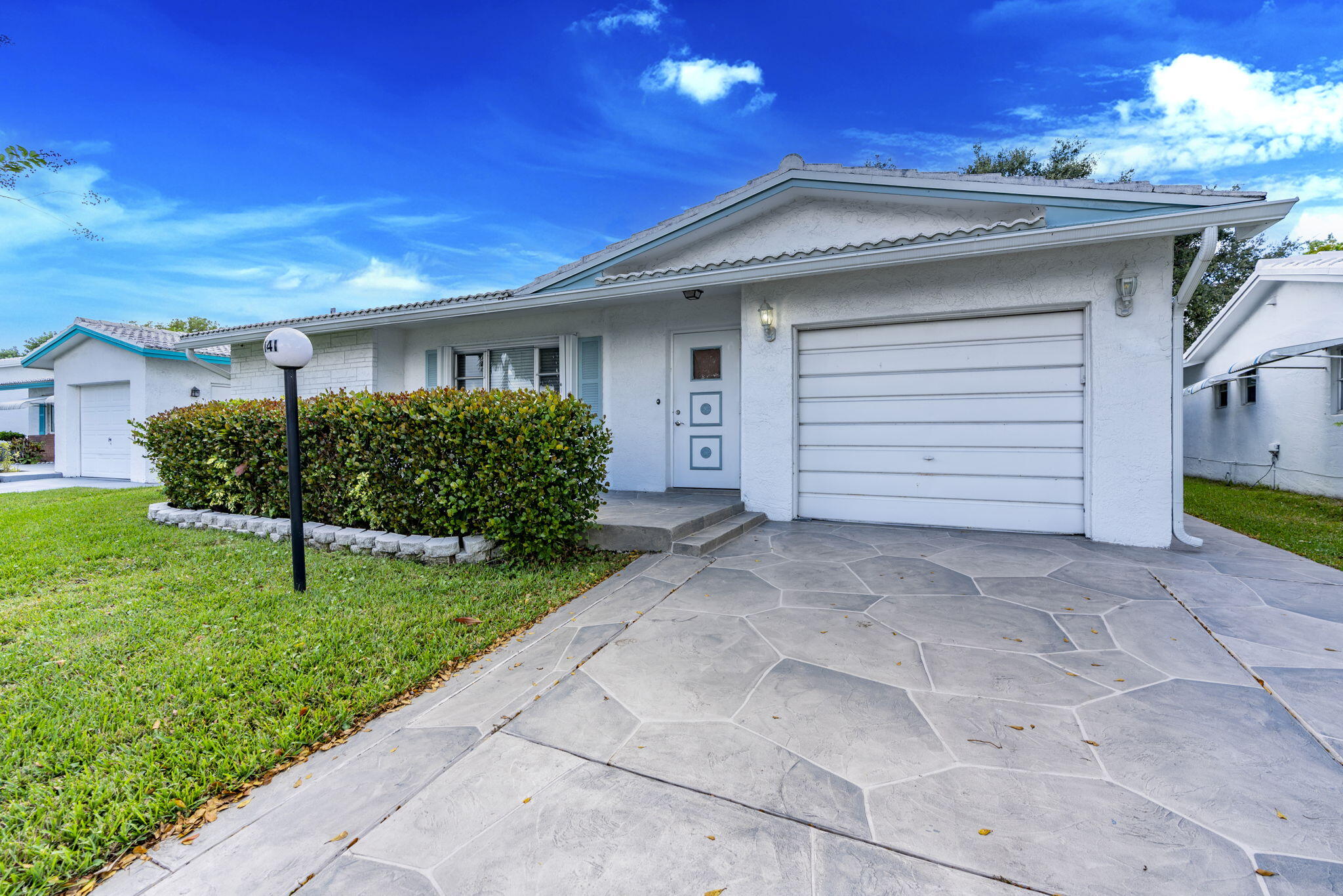 Clean and move-in ready property in Lauderdale West, a Pet-free 55+ Community! This spacious layout features 3 bedrooms plus a den/office. Enjoy easy living with tile throughout and laminate in select areas, along with a freshly resurfaced driveway for great curb appeal. The home includes two master bedrooms, ideal for guests, multi-generational living, or additional space to spread out. The primary suite features a large walk-in closet with built-in shelving and an updated master bathroom complete with dual sinks and a walk-in shower. The kitchen is tastefully designed with dark wood cabinetry, granite countertops, and stainless appliances. An enclosed patio provides a cozy spot for relaxing, and the separate utility room adds extra storage-complete with a brand-new washer and dryer.