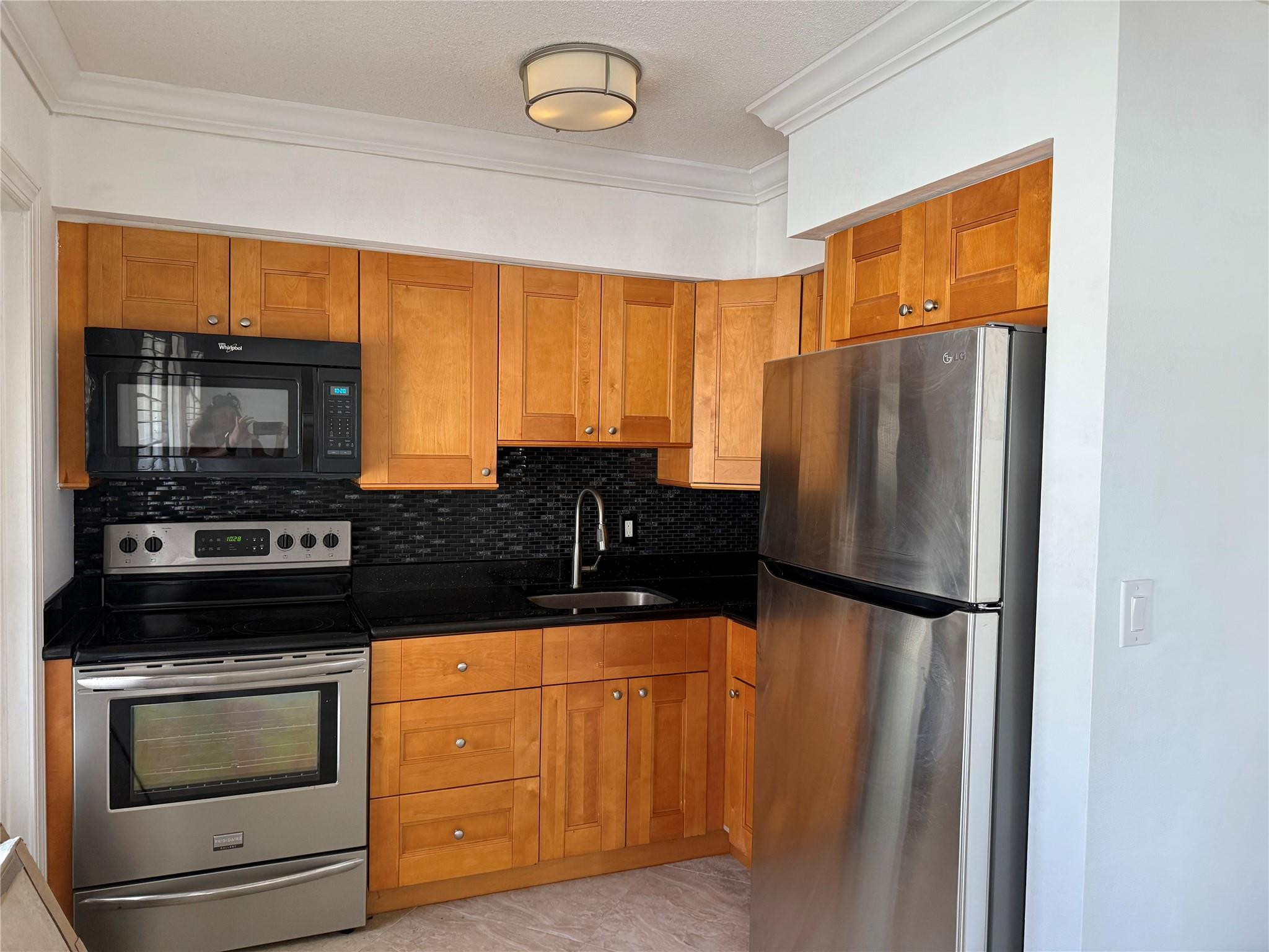 Spacious condo currently configured as a 1BR for more living space, but tax roles says its a 2BR- easily convert back.  Features include an updated kitchen, neutral tile flooring, central A/C, and a newly installed bathroom vanity. The bedroom offers two closets with custom built-ins. Located east of US-1, just minutes from grocery stores, restaurants, the post office, and more. Ideal for full-time or seasonal living at an affordable price. Active 55+ community with a pool and clubhouse. Nestled in a waterfront community of multi million dollar homes, this condo has an ideal location. Photos have been virtually furnished to help see potential.