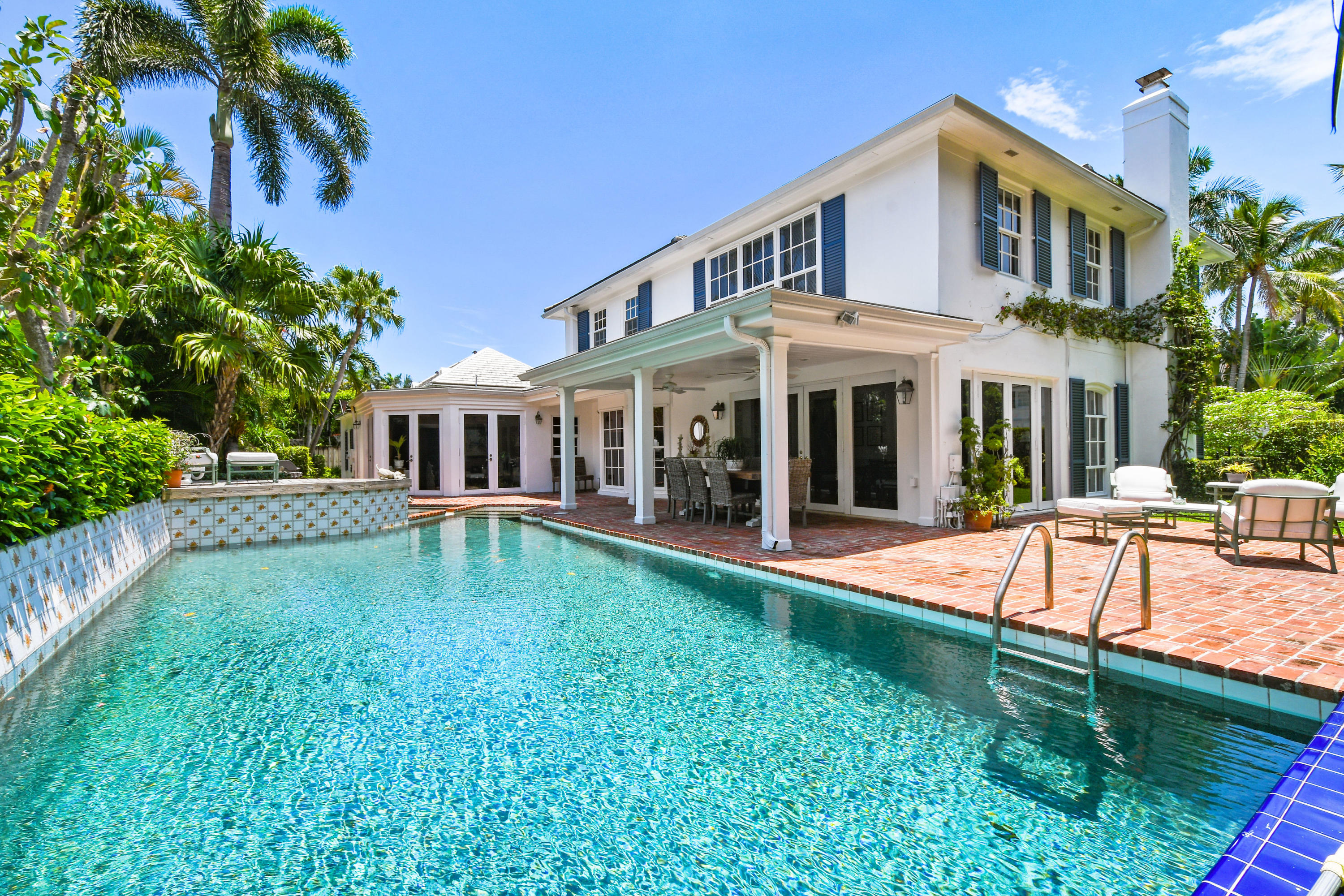 Located in town on prestigious Barton Avenue this elegant 4,590+/- total square foot residence offers 5 bedrooms, and 5 full baths.  Situated on an approximately 120' x 87' lot, the property has an array of wonderful outdoor spaces for both relaxing and entertaining. One can enjoy dining al fresco under the covered loggia or on the terrace, swimming in the pool, or finding calm in the spa.  The home's living room boasts a fireplace and large windows with views to the garden.  The sun room, filled with natural light, has a bar, and French doors that open to both the covered loggia and the terrace. The formal dining room has a bay window looking out to the tranquil pool with fountains.  The eat-in kitchen is appointed with a Viking gas range and oven, a Sub Zero refrigerator, wine fridge, ample storage, a built-in desk, and much more. Directly off of the kitchen is the family room with doors leading out to the terrace. Two guest bedrooms are located on the first floor. The master suite and two additional guest bedrooms are on the second floor.  Each bedroom has an en suite bath and closet.  
Other features include: a half basketball court, 2-car garage, sun deck, and security system.
Barton Avenue is conveniently located in close proximity to the Breakers Hotel, the Atlantic Ocean, the Lake Trail, the Recreation Center, the Royal Poinciana Plaza, restaurants, shopping, and Worth Avenue.