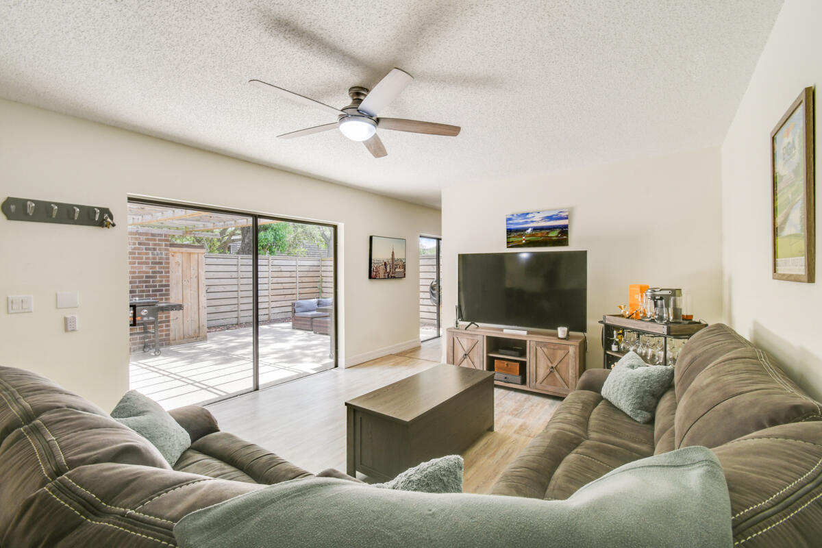 Welcome to this beautifully updated 2-bedroom, 2.5-bath townhouse nestled in the heart of the prestigious PGA National - home to the renowned PGA Tour Cognizant Classic. Boasting elegant design and an exceptional layout, this residence offers the perfect balance of luxury, comfort, and privacy. Step inside to discover brand-new flooring throughout and a newly renovated kitchen featuring modern cabinetry, sleek countertops, and updated appliances. The open-concept floor plan also includes a spacious den/office, perfect for working from home or converting into a guest retreat. Enjoy seamless indoor-outdoor living with an expansive private patio, perfect for relaxing after a long day at work, hosting dinner parties, or soaking up Florida's year-round sunshine. A new roof and new fencing offer added peace of mind and a polished exterior aesthetic. Retreat to the generous bedrooms, each with expansive closet storage, while the master bedroom features its own en-suite bath for added convenience. An outdoor storage shed provides additional space for seasonal items or sporting equipment, and two assigned spaces ensure easy parking. Located within a secure, gated community with amazing amenities, you'll enjoy easy access to championship golf courses, walking trails, resort-style pools, tennis facilities and more!  all inside the world-renowned PGA National enclave.