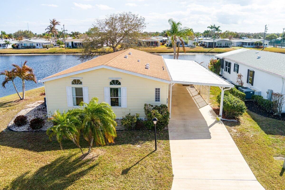 PANORAMIC WATERFRONT! Fantastic Location! NEW AC May 2026.  Enjoy breathtaking sunset water views from your own Florida home! This 2-bed, 2-bath land leased home features all new interior paint, new carpet, 2018-Roof, 2026-AC, 2019-Hot Water Heater, New Hickory Laminate Flooring on the Lanai and in the Family Room and Hurricane Shutters for storm protection. Great for entertaining. Storage Room for pool floats and tools. Don't miss your opportunity to own a slice of Florida in the highly desired Savanna Club. Experience the best of 55+ living with resort style amenities featuring staffed clubhouses, fitness center, 3 swimming pools, tennis, pickle ball, 10,000sf theater, 18 hole golf course, restaurant, etc. Take time to relax or stay busy with the community social calendar.