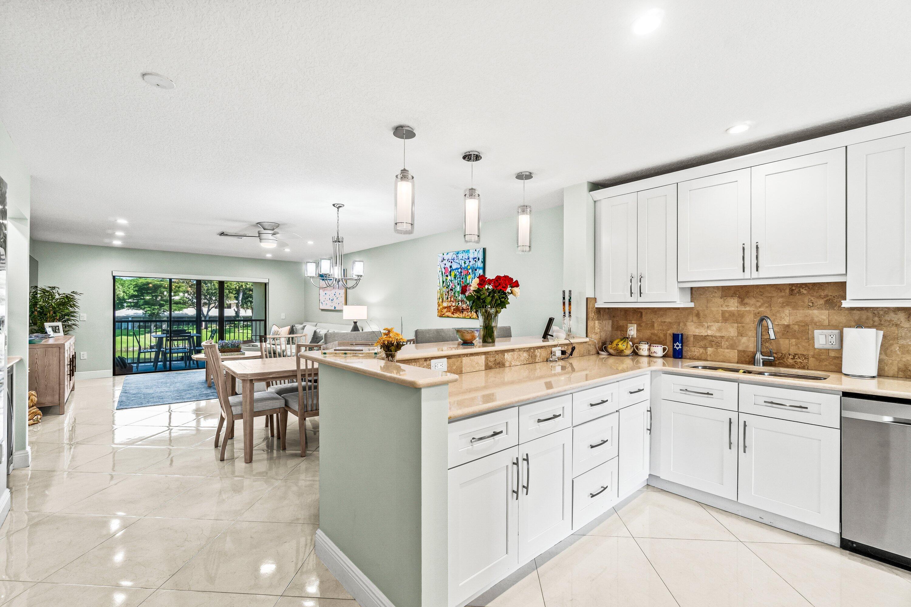 Welcome to this fully remodeled 2BR/2BA residence in Stratford at Hunters Run Country Club, offering an open-concept layout with sleek porcelain tile flooring throughout. The contemporary kitchen flows seamlessly to the dining and living areas, ideal for relaxing or entertaining. Retreat to the spacious primary suite with spa-style en-suite bath featuring a seated shower and dual sinks. Guests will enjoy a large secondary bedroom with semi-private bath. Take in stunning water views from the screened terrace. Unit includes 50% ownership of a newer elevator lift for added convenience. Move right in and enjoy Hunters Run's resort-style amenities including golf, tennis, pickleball, pool, fitness center, spa, dining and nonstop social events. Mandatory membership. Experience world-class club living with 54 holes of championship golf, 18 tennis courts, 12 pickleball courts, a resort-style clubhouse and pool, salon & spa, fitness center, and six dining venues. Brand new racquet sports center coming soon!