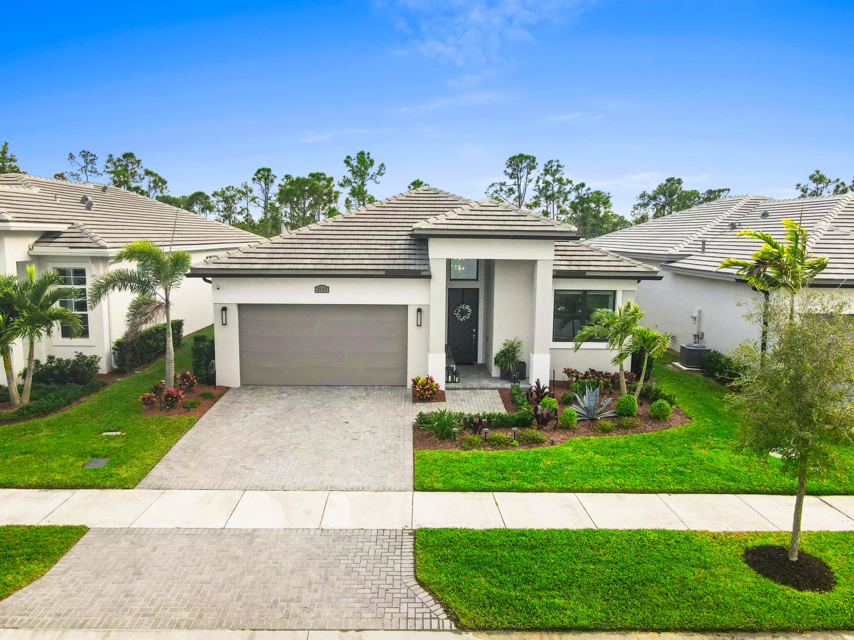 Why wait to build? This stunning 2023 new construction has it ALL without the wait. Enjoy the indoor-outdoor living with serene private preserve views and southern exposure on your extended lanai. Stunning open-floor plan is perfect for entertaining with large quartz kitchen island & gas cook top. High ceilings and natural light throughout. Spacious owners suite features tray ceiling, large walk in closet, and spa like bathroom. 3 additional bedrooms to there's room for everyone. CBS construction with Hurricane Impact windows for peace of mind. Just a short walk to the clubhouse for the pool, gym & pickleball in this all ages community of Mosaic. Only 20 minutes to the beach, 15 minutes to tradition and less than 2 miles to Publix, shopping, dining, new hospital & FL Turnpike