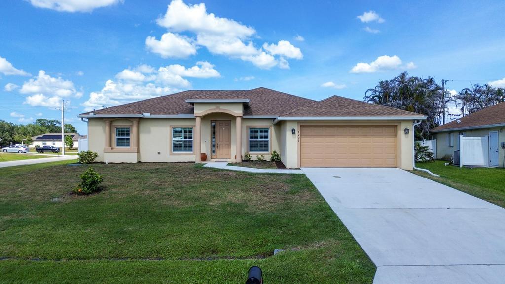 Welcome to this spacious single-story home in Port St. Lucie near Becker and easy access to major highways.  Built in 2021, this move-in-ready corner lot home offers the perfect blend of modern style and convenience. Featuring impact windows and doors, tile flooring throughout, and a desirable open split-bedroom floor plan, this home includes 4 bedrooms, 3 bathrooms, plus a den/office. The spacious kitchen and bathrooms showcase granite countertops and wood cabinetry. The primary suite features dual sinks and a large walk-in shower. Enjoy Florida living in the vinyl-fenced backyard with both covered and open patio spaces, perfect for entertaining, relaxing, or family gatherings.
