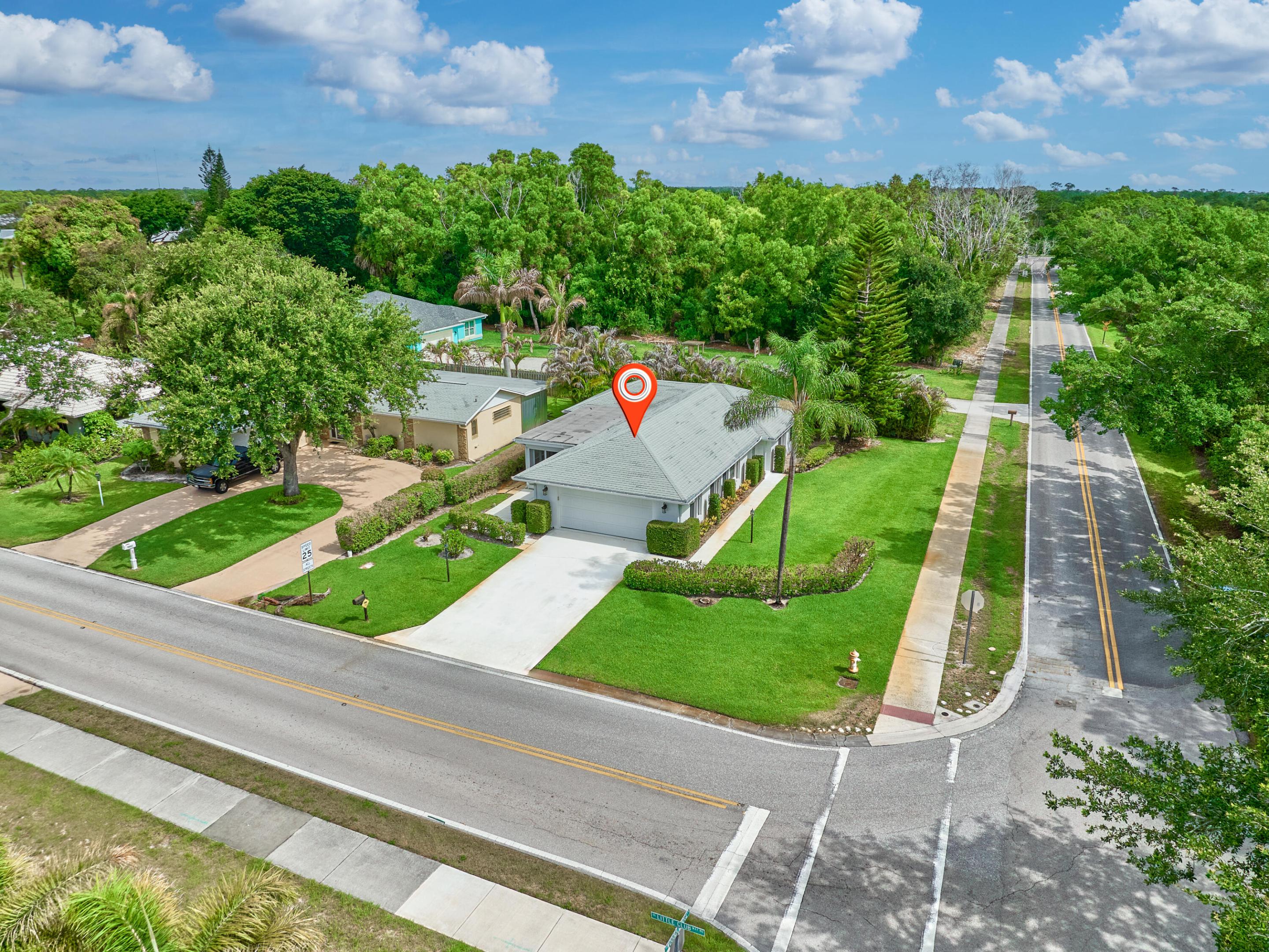 Updated 1,304sf, Single Family Home, 2 Beds, 2 Full Baths, 2 Car Garage. Little Club is a 55+ Community Move-in Ready! Large Corner Lot, Kitchen Features: Granite Countertop, Real Wood Cabinets, NEW Stainless Refrigerator, Large Primary Bedroom features Updated Ensuite FULL Bath, Open Floor Plan, Vaulted Ceiling in Living Room and Dining Area. Tile & Laminate (NO Carpet), Enclosed Tiled Patio perfect for entertaining. Large 2 Car Garage with Separate AC, Newer Washer & Dryer, Laundry tub & workbench. FULL ACCORDION SHUTTERS & Impact Front Door. Newer AC 2020, Water Heater 2018, Roof 2010. Little Club's Low HOA includes: Community Pool, Clubhouse, Tennis / Pickleball, Shuffleboard, Golf and much more! Minutes drive to Jupiter Beach, Shopping & Much more! By appt. Call for a private showing. CBS Block home  55+ Community  Refrigerator GE 2026 Dishwasher LG 2022 HVAC 2020 Water Heater 2018 Microwave Whirlpool 2018 Dryer Samsung 2011 Washing Machine Samsung 2008  Gutters Storm Accordion Shutters Exterior Lighting Enclosed Patio Separate AC in Garage