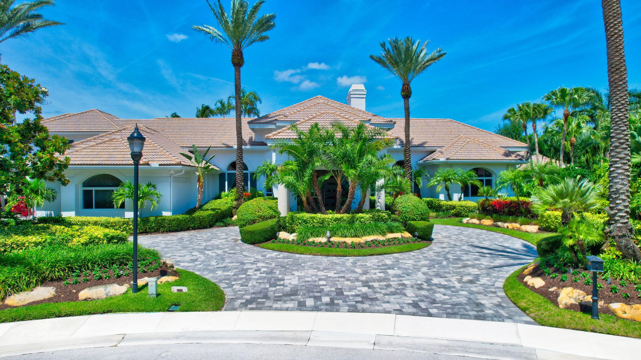 MAGNIFICENT DOUBLE LOT ESTATE SITUATED ON 284' OF PRISTINE WATERFRONT IN GRAND OAKS AT BROKEN SOUND COUNTRY CLUB! 8,328 SF OF PURE LUXURY NESTLED ON A CUL-DE-SAC ON .88 ACRE! 6 EN-SUITE BEDROOMS + OFFICE, 7.2 BATHS & FLOOR TO CEILING IMPACT WINDOWS WITH PANORAMIC VIEWS OF THE GOLF FAIRWAYS & LAKES! PALATIAL PRIMARY BEDROOM SUITE WITH PRIVATE SITTING AREA, A SPA INSPIRED BATHROOM & HIS/HER CLOSETS!  UPSTAIRS PRIVATE RETREAT WITH FULLY EQUIPPED KITCHEN,  LIVING ROOM & EN-SUITE BEDROOM! GUEST HOUSE WITH COVERED BREEZEWAY TO THE MAIN HOUSE! GOURMET CHEF'S KITCHEN WITH CUSTOM CABINETS, QUARTZ COUNTER TOPS, DOUBLE OVENS & WINE COOLER! EXPANSIVE PATIO WITH OUTDOOR DINING, RESORT STYLE POOL WITH JACUZZI, WATER SPOUTS AND SWIM UP POOL BAR WITH BBQ, TROPICAL FOUNTAIN AND INTIMATE SEATING AREAS! Nestled on a tranquil cul-de-sac within the prestigious Broken Sound Country Club, this extraordinary Grand Oaks double-lot estate redefines luxury living. As you approach the magnificent residence, you are immediately captivated by its commanding presence spanning 284 feet of pristine waterfront. Step inside to discover 8,328 square feet of uncompromising elegance where every detail has been meticulously curated for those who demand the exceptional.

Floor-to-ceiling impact windows frame breathtaking panoramic views where emerald golf fairways meet sparkling lake waters, creating a living canvas that changes with the light. The six en-suite bedrooms, including a palatial primary bedroom with private sitting area and spa-inspired bathroom, offer luxury for family and guests. An additional executive office provides the perfect balance of productivity and pleasure.

The private upstairs retreat offers complete independence with its own en-suite bedroom, fully-equipped kitchen, and private living space - perfect for long-term guests or family members seeking their own sanctuary within your home. 

Enhancing this estate's appeal is a private wing, thoughtfully connected to the main residence via an elegant covered breezeway. This exclusive space features a bedroom, full bathroom, and a generous closet, providing all the comforts of private quarters. It is a perfect accommodation for visiting guests, live-in staff, or multi-generational living arrangements and is currently used as a gym.  With direct access to the resort-style pool area, guests can seamlessly transition to the outdoor paradise. 
 
The gourmet chef's kitchen stands as a testament to both function and beauty, featuring custom cabinetry and top-of-the-line appliances including double ovens and dual dishwashers for effortless entertaining.  A sophisticated wine cooler preserves your collection at optimal temperatures, while the dramatic waterfall island serves as both a stunning focal point and practical workspace.  Magnificent windows that flood the space with natural light, framing breathtaking views and elevating everyday cooking into an extraordinary experience.
   
The true magic unfolds in the resort-style outdoor oasis, where entertainment possibilities are limitless. Host sophisticated soirées on the expansive terrace adorned with a mesmerizing fountain or enjoy intimate al fresco dining by the summer kitchen while watching the sunset reflect on the water. The freeform salt water heated pool with playful water spouts, swim up pool bar and integrated jacuzzi invites both energetic swims and peaceful relaxation. As evening descends, multiple thoughtfully designed seating areas transform into intimate gathering spaces under the stars.

This isn't merely a home - it's a private paradise where luxury, nature, and lifestyle converge to create an unparalleled living experience at Grand Oaks, Broken Sound Country Club. 
 
THE CLUB:
You will experience unparalleled luxury at the prestigious Broken Sound Country Club, where world-class amenities meet championship excellence. Home to two world-renowned golf courses, including the legendary Old Course that has proudly hosted the PGA Championship Season Opener for 17 consecutive years.  This exclusive community offers the ultimate in resort-style living. Dive into relaxation at the stunning aquatics center featuring a dramatic waterfall and water slide, then indulge your palate at any of five exceptional dining venues ranging from casual fare to exquisite fine dining. Rejuvenate your body and mind in the state-of-the-art spa and fitness center, or perfect your game on 21 pristine clay tennis courts and 8 pickleball courts. This isn't just a home - it's your gateway to a lifestyle of distinction and endless recreation.

FEATURED DETAILS:
-Expansive Double Lot - .88 Acre 
-284' Waterfront 
-Located on Quiet Cul-De-Sac
-Panoramic Views of Golf Fairways and Crystal Lakes
-8,328 Square Feet
-6 En-suite Bedrooms
-7 Full & 2 Half Bathrooms
-2023 Impact Windows & Doors
-2022 Gourmet Chef's Kitchen - Double Ovens, Dual Dishwashers, Wine Cooler
-2022 Two LG Front Load Washers and Two LG Dryers
-Custom Office
-Lutron Controlled Indoor and Outdoor Lighting
-Private Upstairs Retreat - En-Suite Bedroom, Fully-Equipped Kitchen, Private Living Space
-Guest House Attached with Covered Breezeway to Main House
-Whole House Water Filtration System
-3-Car Garage with Tesla Electric Charging Outlet
-2022 Refinished Resort-Style Salt Water Heated Pool & Jacuzzi
-2022 All New Porcelain Pavers on Terrace
-Aqualink Control Pool, Jacuzzi & Fountain
-2022 Entire House Painted
-Pool Bar with Outdoor BBQ Summer Kitchen
-Tropical Fountain Feature
-2022 All New Pavers on Driveway and Walkway

THE CLUB:
You will experience unparalleled luxury at the prestigious Broken Sound Country Club, where world-class amenities meet championship excellence. Home to two world-renowned golf courses, including the legendary Old Course that has proudly hosted the PGA Championship Season Opener for 17 consecutive years.  This exclusive community offers the ultimate in resort-style living. Dive into relaxation at the stunning aquatics center featuring a dramatic waterfall and water slide, then indulge your palate at any of five exceptional dining venues ranging from casual fare to exquisite fine dining. Rejuvenate your body and mind in the state-of-the-art spa and fitness center, pamper yourself in the full service salon, or perfect your game at the USTA ranked tennis center featuring 21 pristine clay tennis courts and 8 pickleball courts. This isn't just a home - it's your gateway to a lifestyle of distinction and endless recreation.