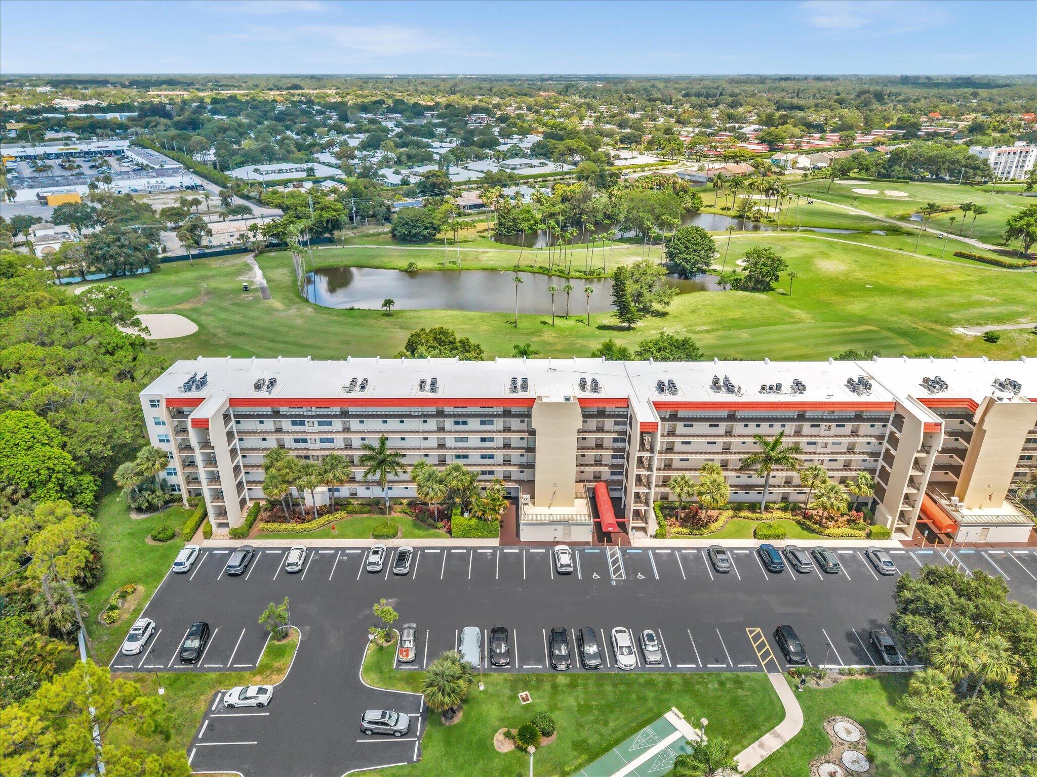 Two bedroom, two bathroom condominium overlooking the beautiful Poinciana golf course in Lake Worth, FL. This well-proportioned residence offers 1,103 square feet of finished living space. This unit features an enclosed patio with brand new floor to ceiling hurricane impact windows. Impact windows and doors just installed in 2026. Unit is move in ready with new vinyl floors, updated kitchen and bathrooms. Upgrades include an ADT alarm system and Nest thermostat. Situated within the Poinciana Place community, amenities include golf, pool, tennis, a restaurant, and clubhouse. New sporting area with bocce ball & horseshoes is planned. Monthly association fee covers internet, cable with HBO.