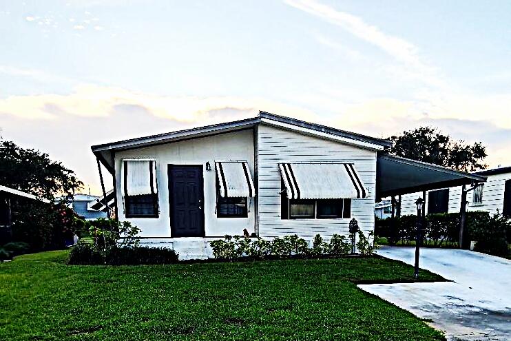 Desirable 55+ community where you own the land, and pets are welcomed.This spacious 2 bedroom 2 bath offers spacious living with 1320 sq ft.The open concept living space and separated bedrooms are ideal for family and guests. It's perfect for seasonal or full time living.The primary suite has walk in shower and in house washer and dryer. AMS roof installed 2011, AC 2018, irrigation pump 2023. The community boasts a heated swimming pool, shuffleboard, library, billiards and work out room, as well as seasonal dances, dinners, and clubs. A new Publix is a block away, and restaurants, doctors, and golf nearby. The beach is an easy 10 minute drive, and boat ramps and parks 5 mins away.